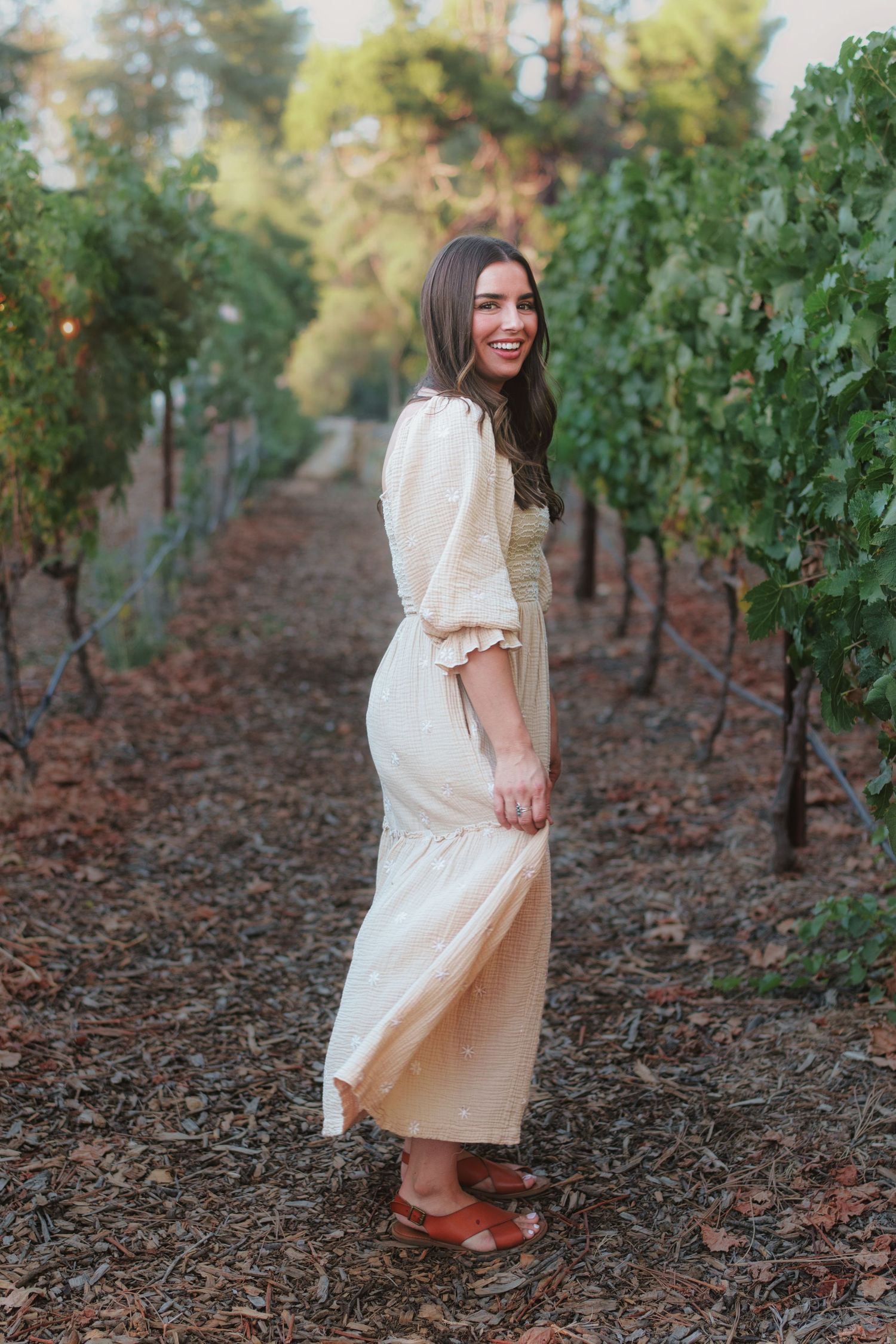 Warm golden hour environmental portrait of a woman  in a sunlit field in Southern California by Vince Shewmaker.