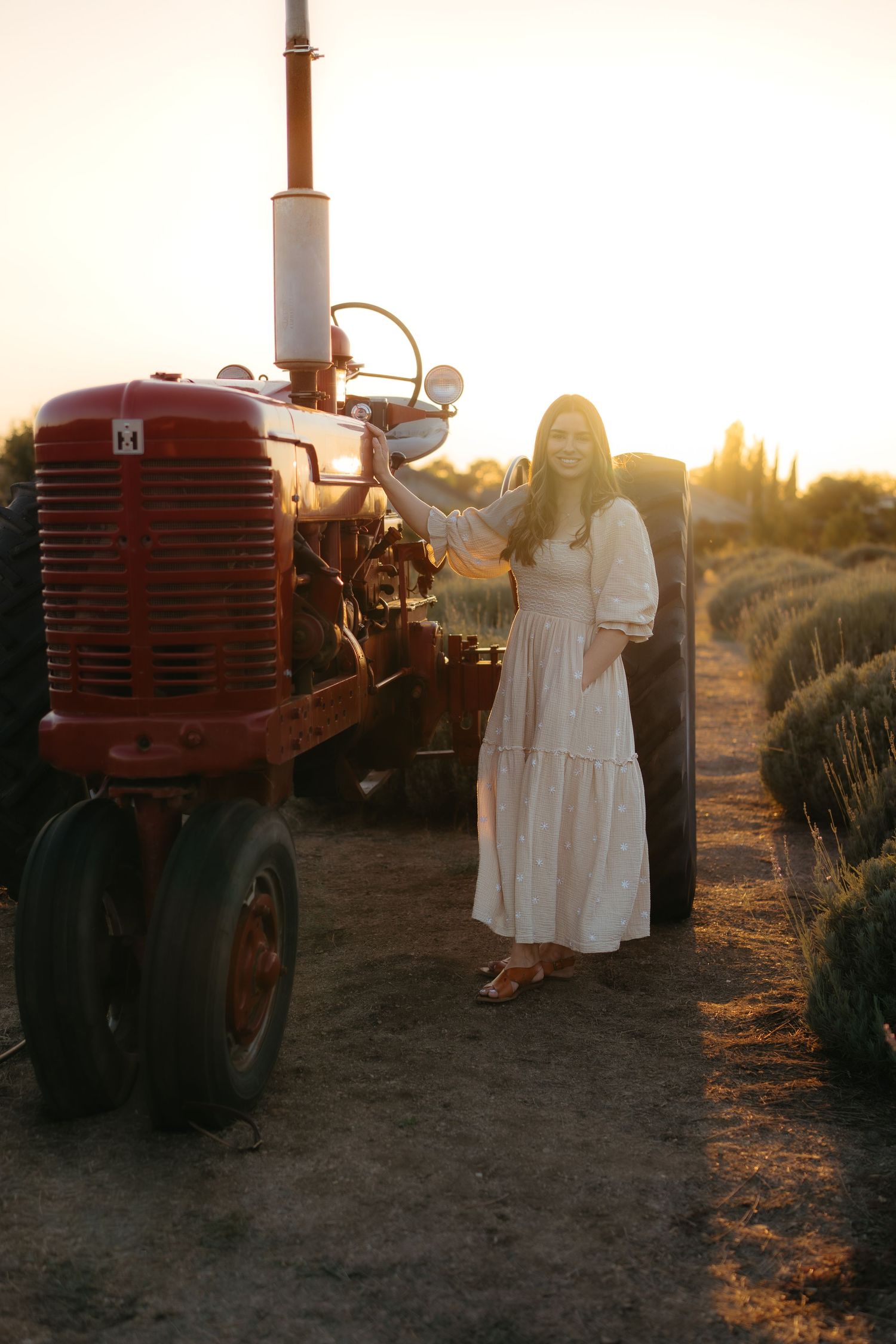 Warm golden hour environmental portrait of a woman in a sunlit field in Southern California by Vince Shewmaker.