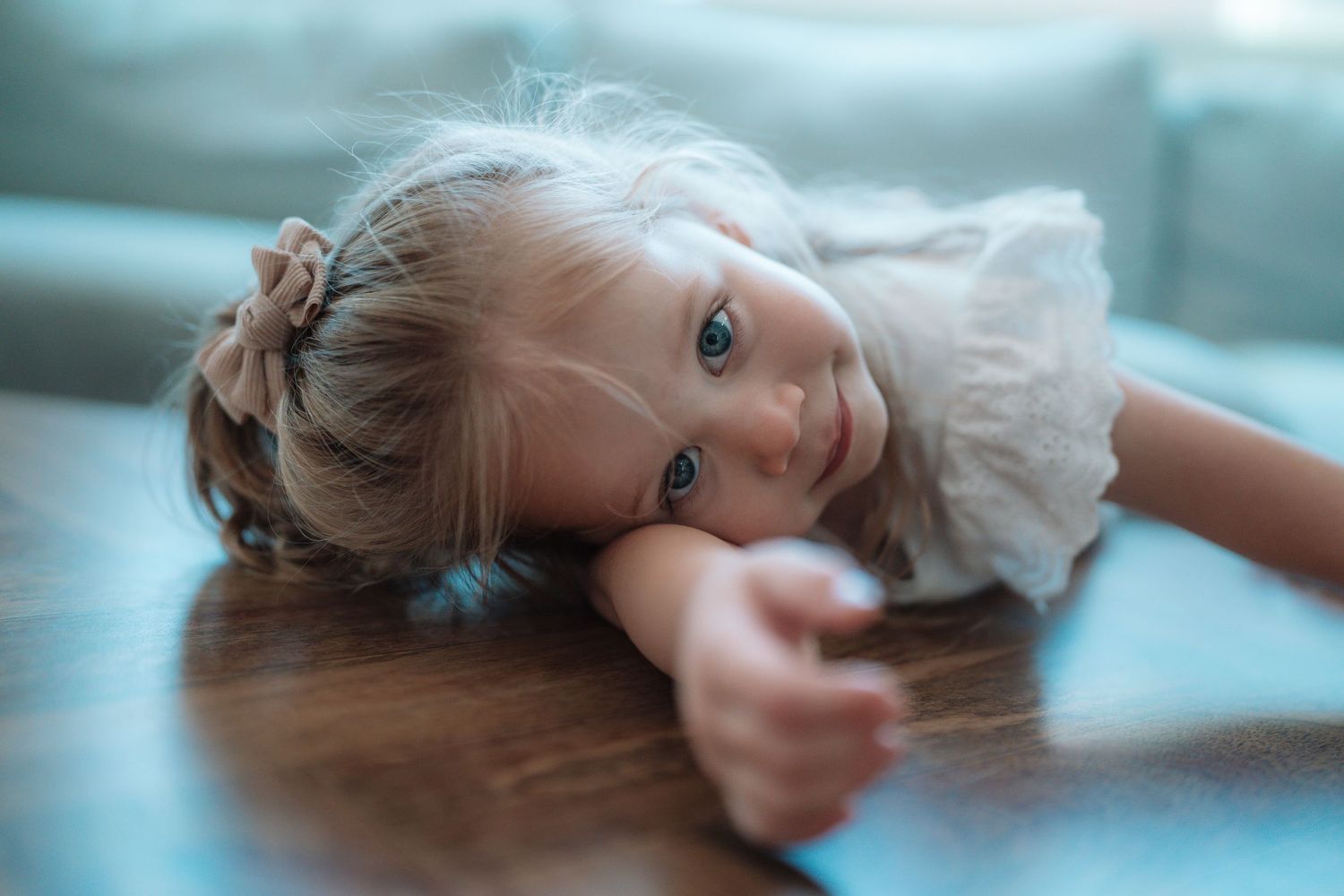 Candid environmental portrait of a young child playing in a natural outdoor setting with soft lighting by Vince Shewmaker.