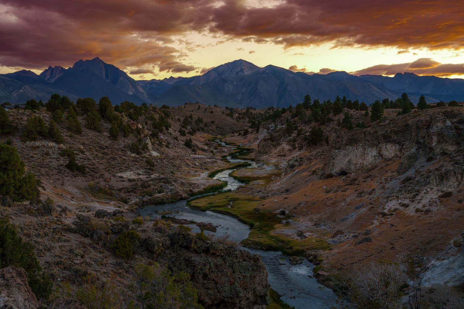Dramatic wide-angle nature photograph of majestic mountains and under a moody sky by Vince Shewmaker.
