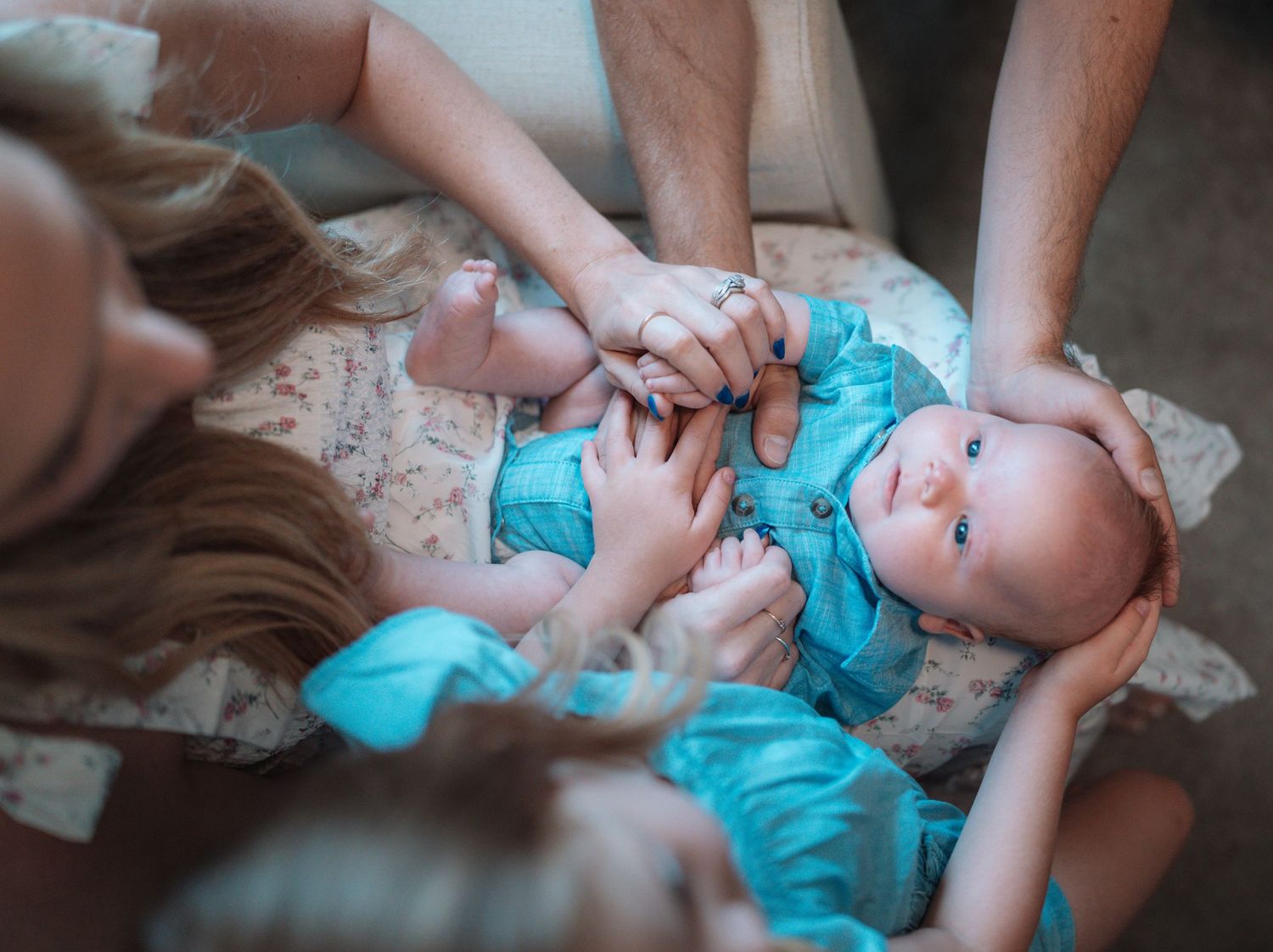 Cinematic outdoor portrait of a family standing together in a rustic natural landscape by Vince Shewmaker.