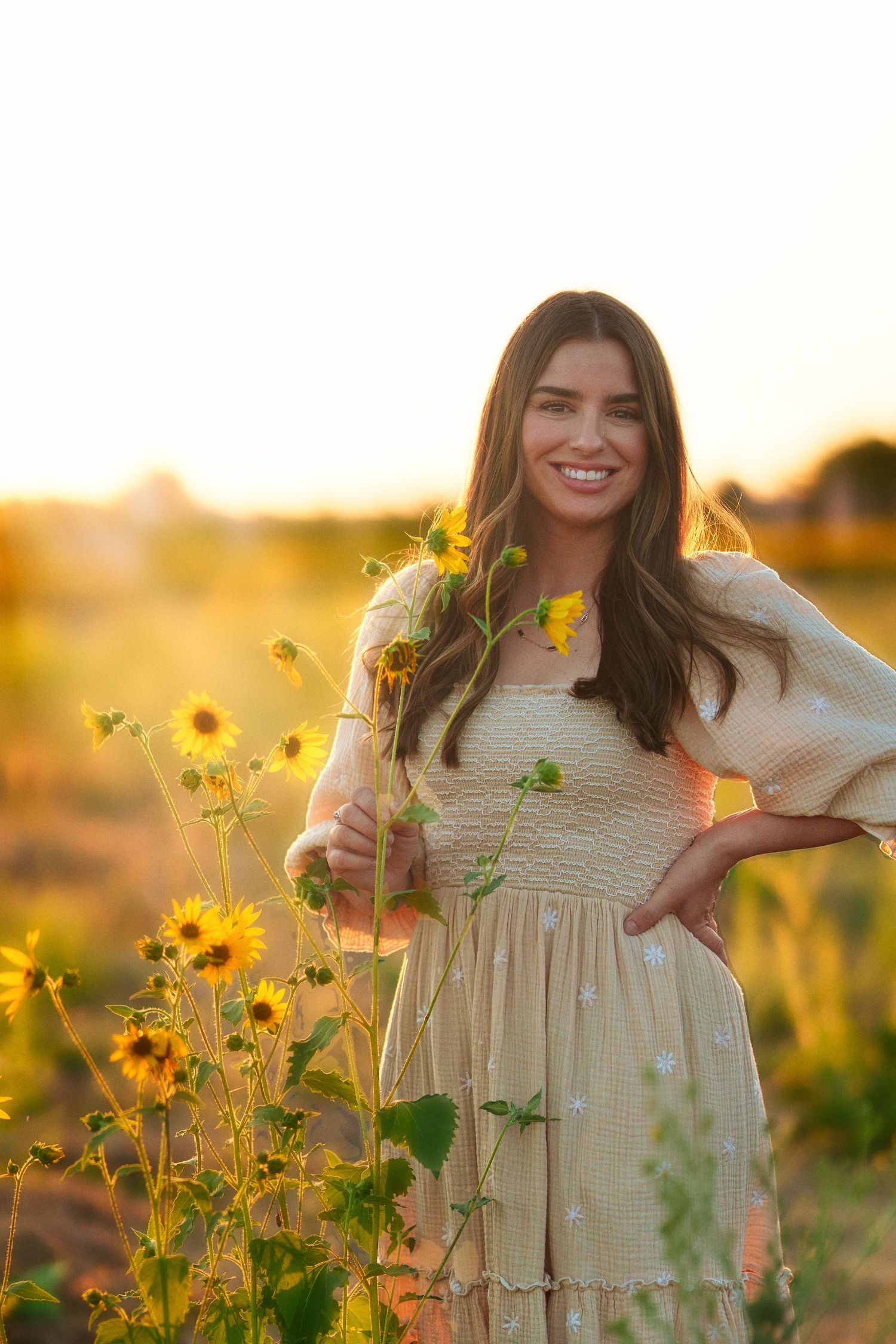 Warm golden hour environmental portrait of a woman  in a sunlit field in Southern California by Vince Shewmaker.