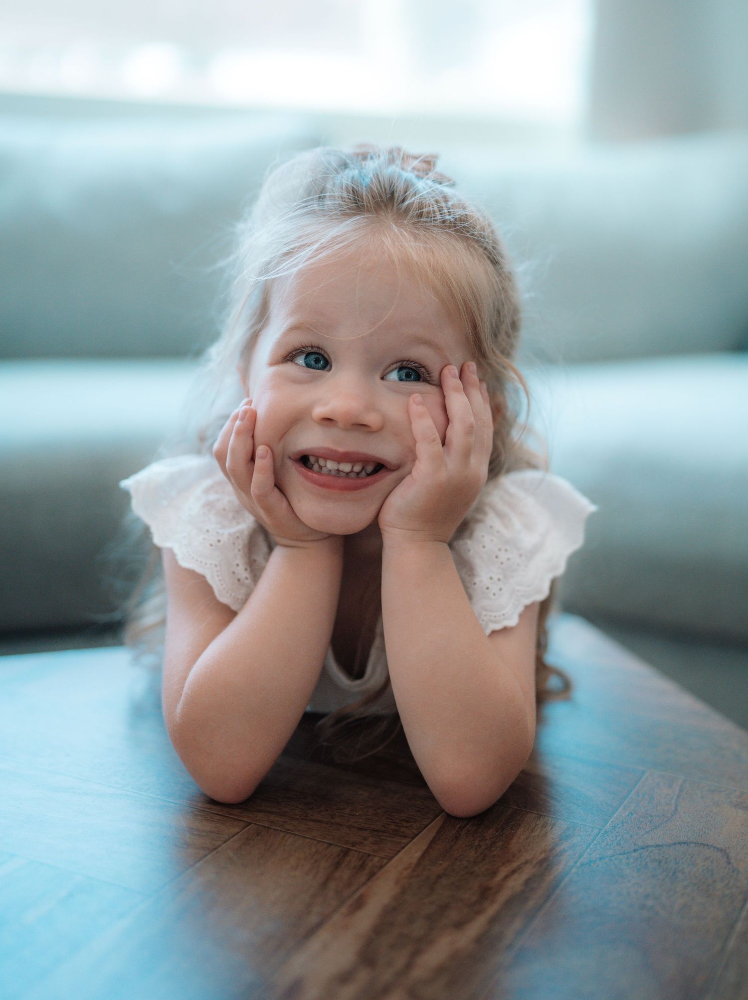 Candid environmental portrait of a young child playing in a natural outdoor setting with soft lighting by Vince Shewmaker.