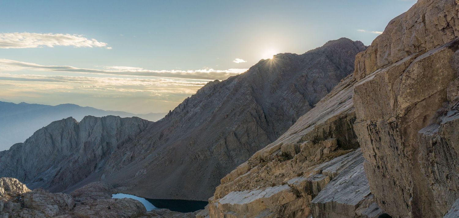 Dramatic wide-angle nature photograph of majestic mountains and under a moody sky by Vince Shewmaker.