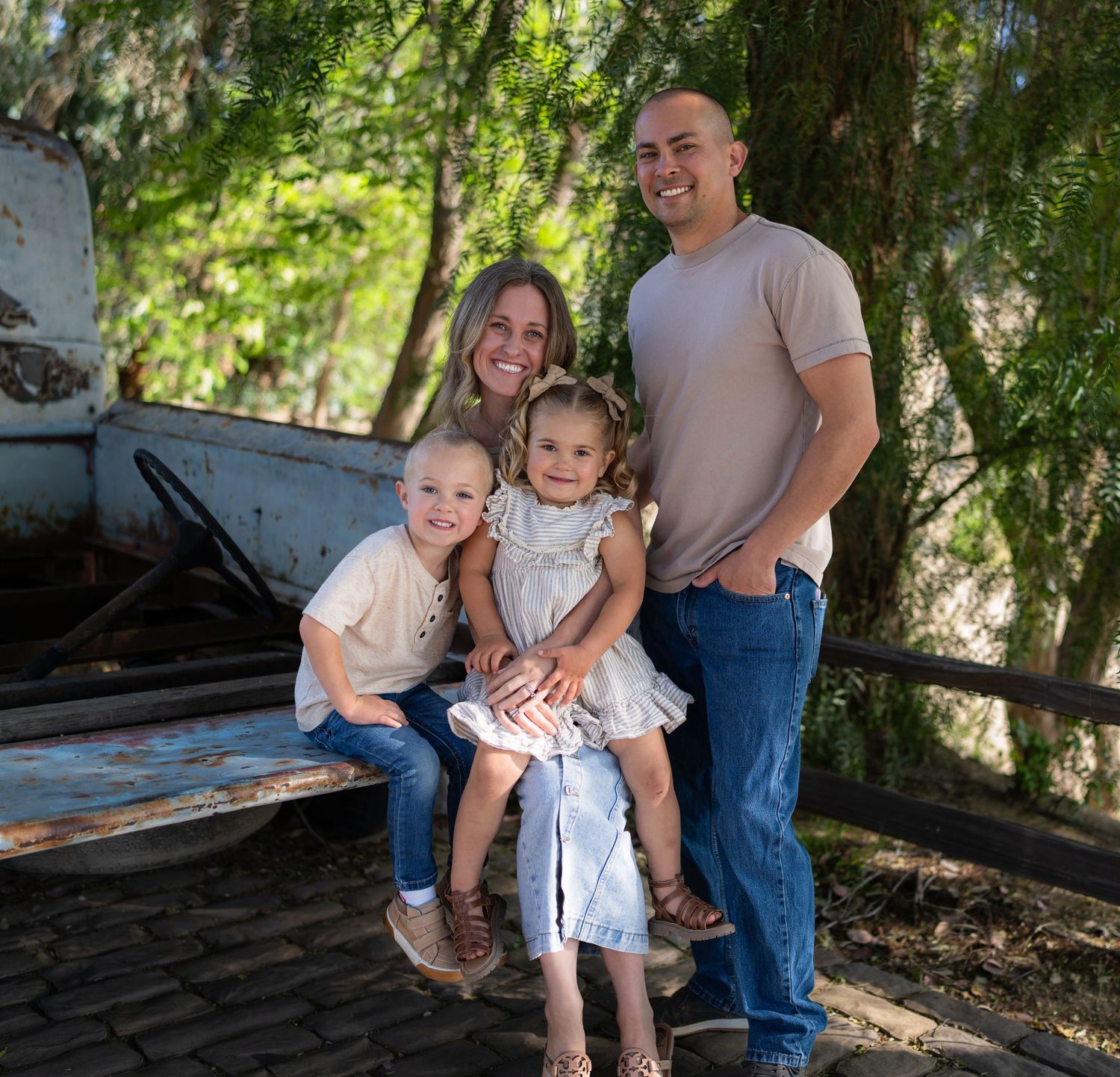 Warm golden hour environmental portrait of a family with children playing in a sunlit field in Southern California by Vince Shewmaker.