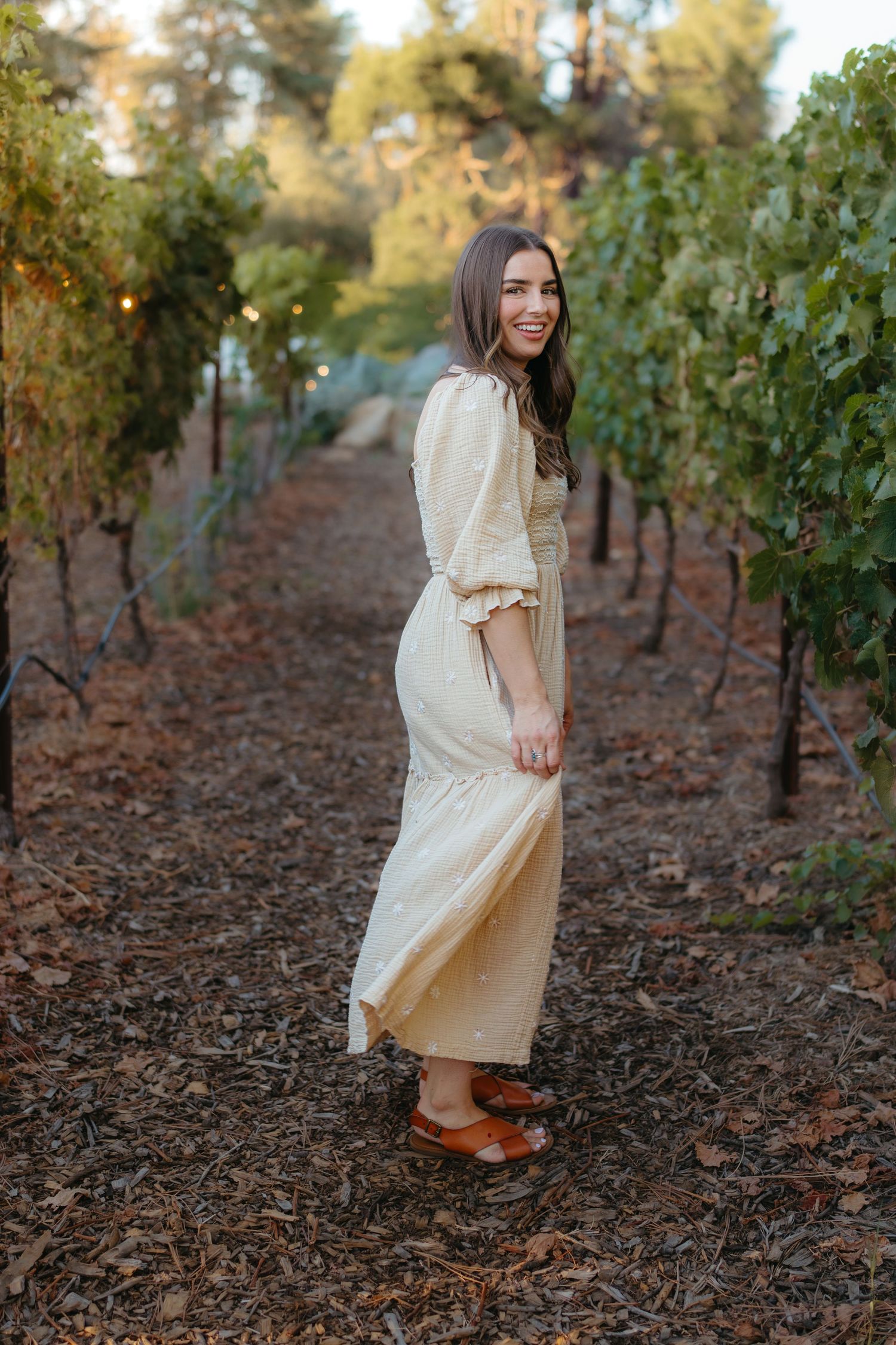 Warm golden hour environmental portrait of a woman in a sunlit field in Southern California by Vince Shewmaker.