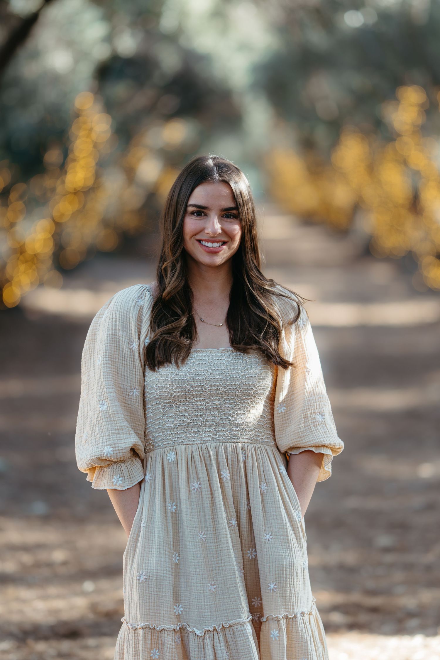 Warm golden hour environmental portrait of a woman in a sunlit field in Southern California by Vince Shewmaker.