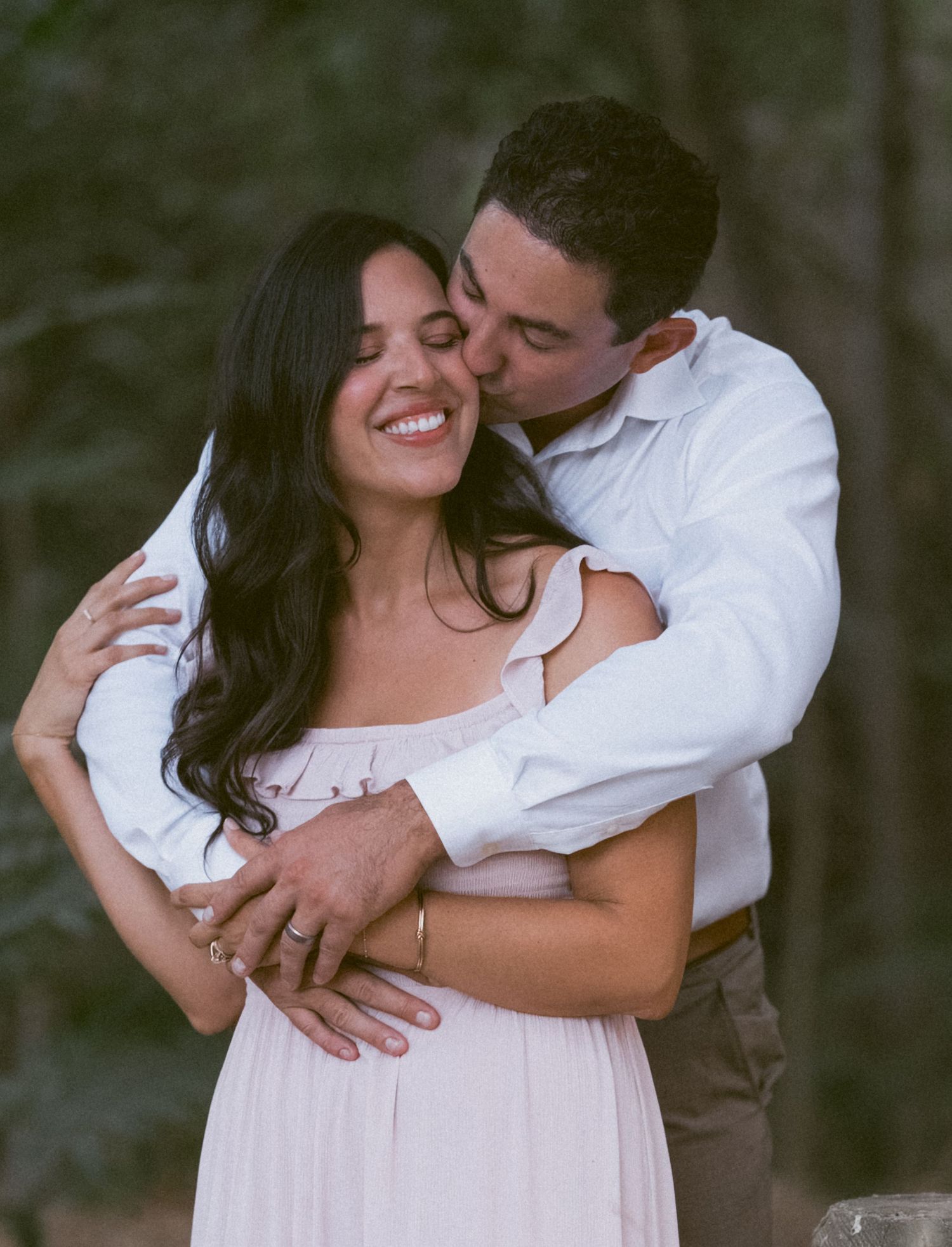 Warm cinematic portrait of a couple embracing in tall grass rolling hills at sunset in the country by Vince Shewmaker.