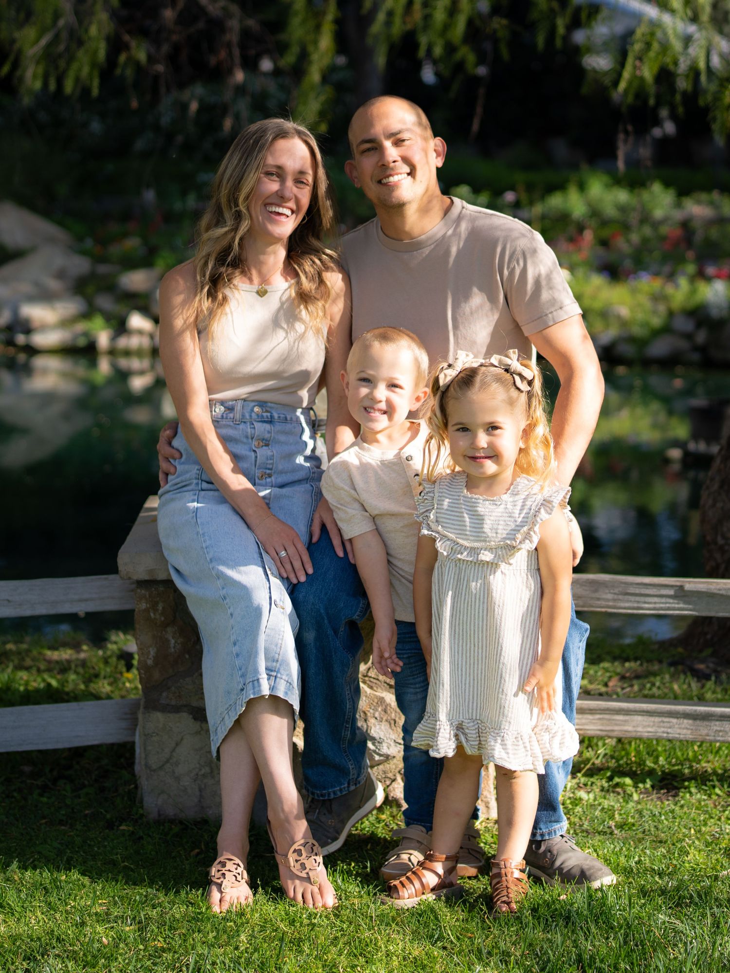 Warm golden hour environmental portrait of a family with children playing in a sunlit field in Southern California by Vince Shewmaker.