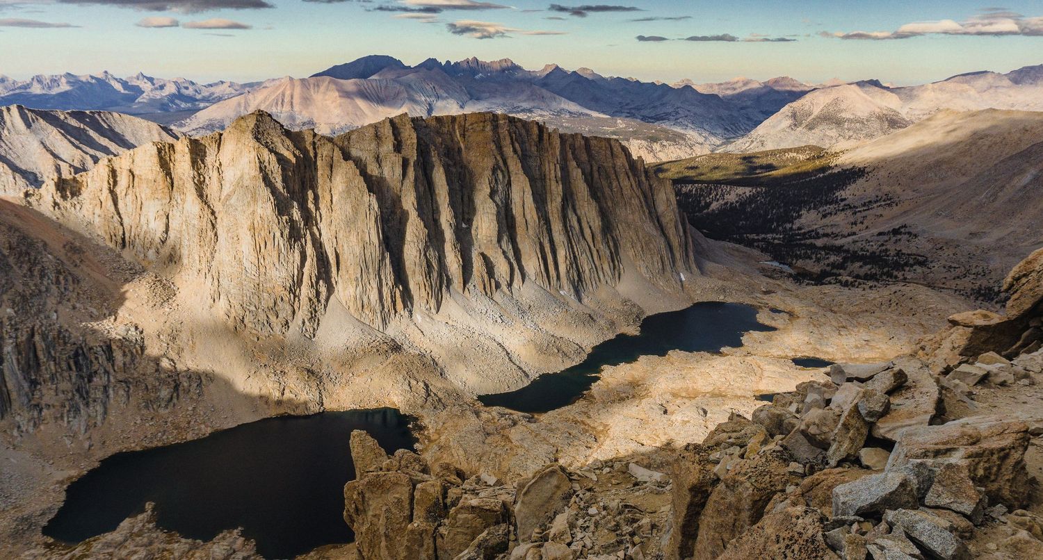 Dramatic wide-angle nature photograph of majestic mountains and under a moody sky by Vince Shewmaker.