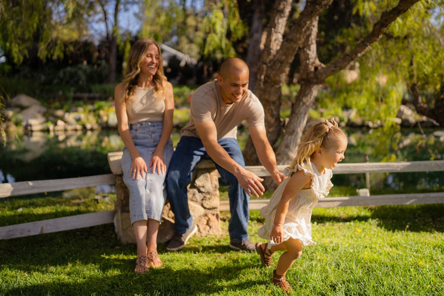 Warm golden hour environmental portrait of a family with children playing in a sunlit field in Southern California by Vince Shewmaker.