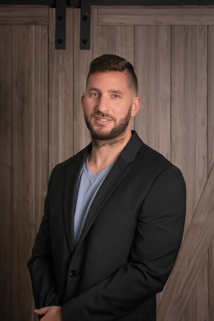Headshot of man in suit and barndoor in background of Lake Worth Florida