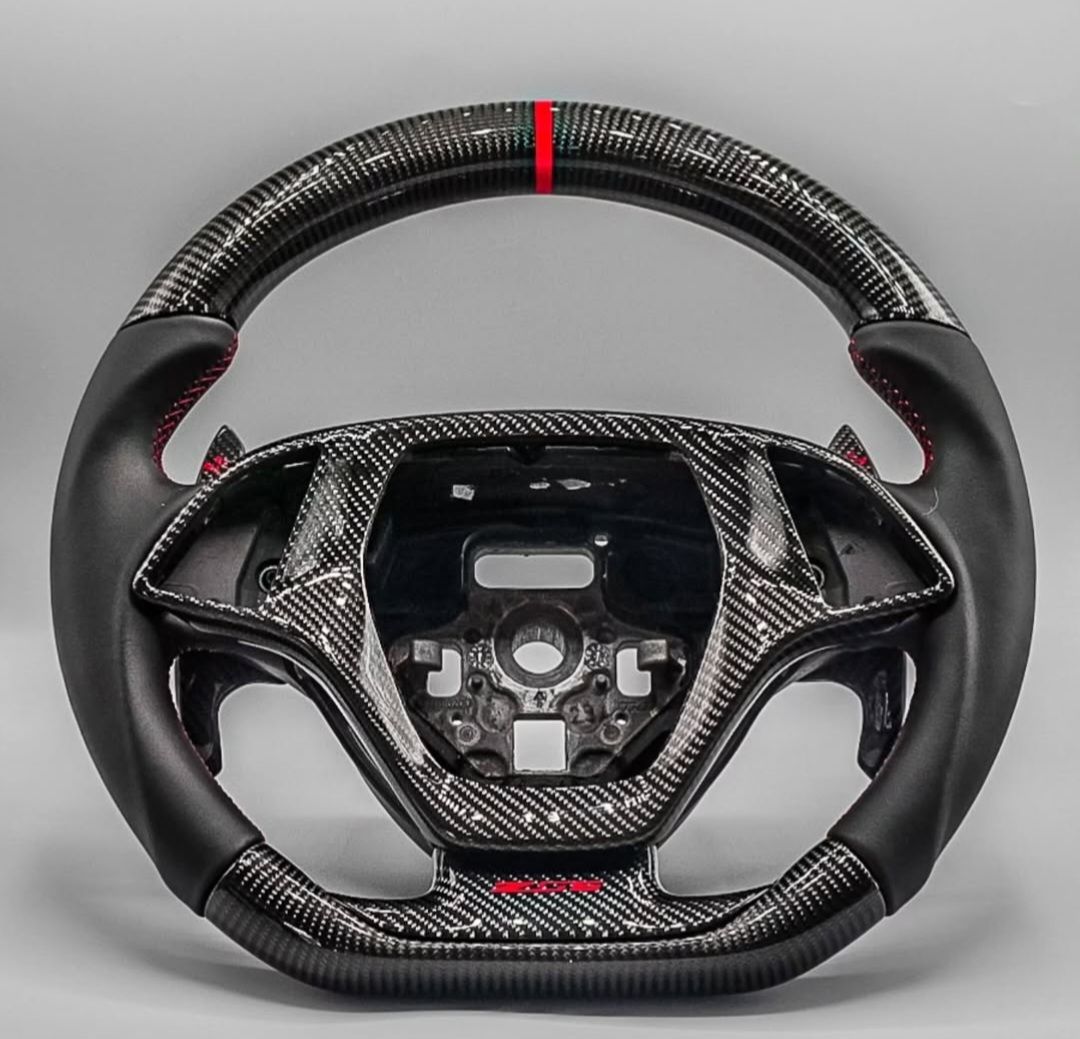 Steering wheel product photography photo of carbon fiber steering wheel in lightbox.