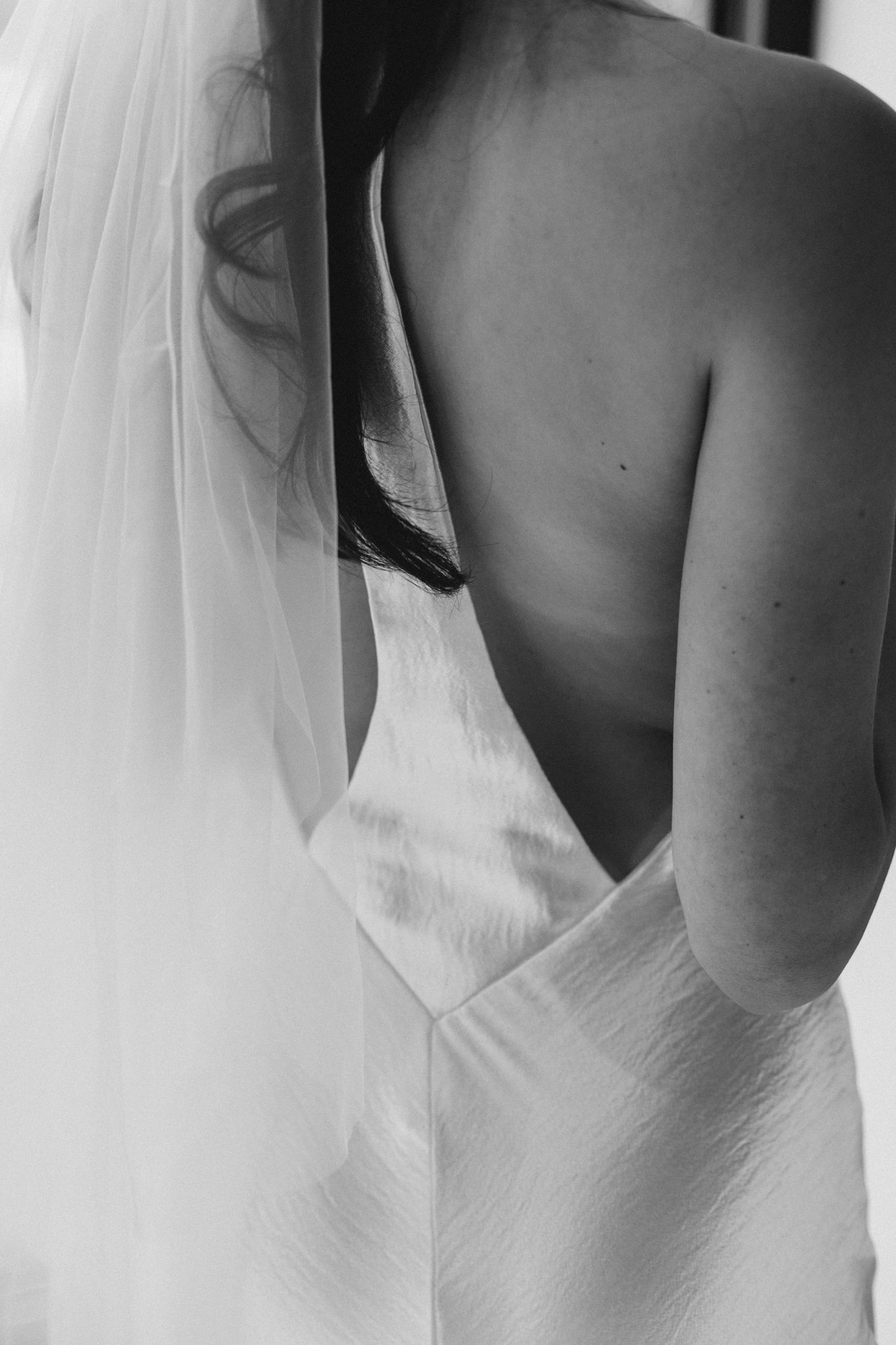 Close-up black and white detail shots of a bride's wedding dress back.