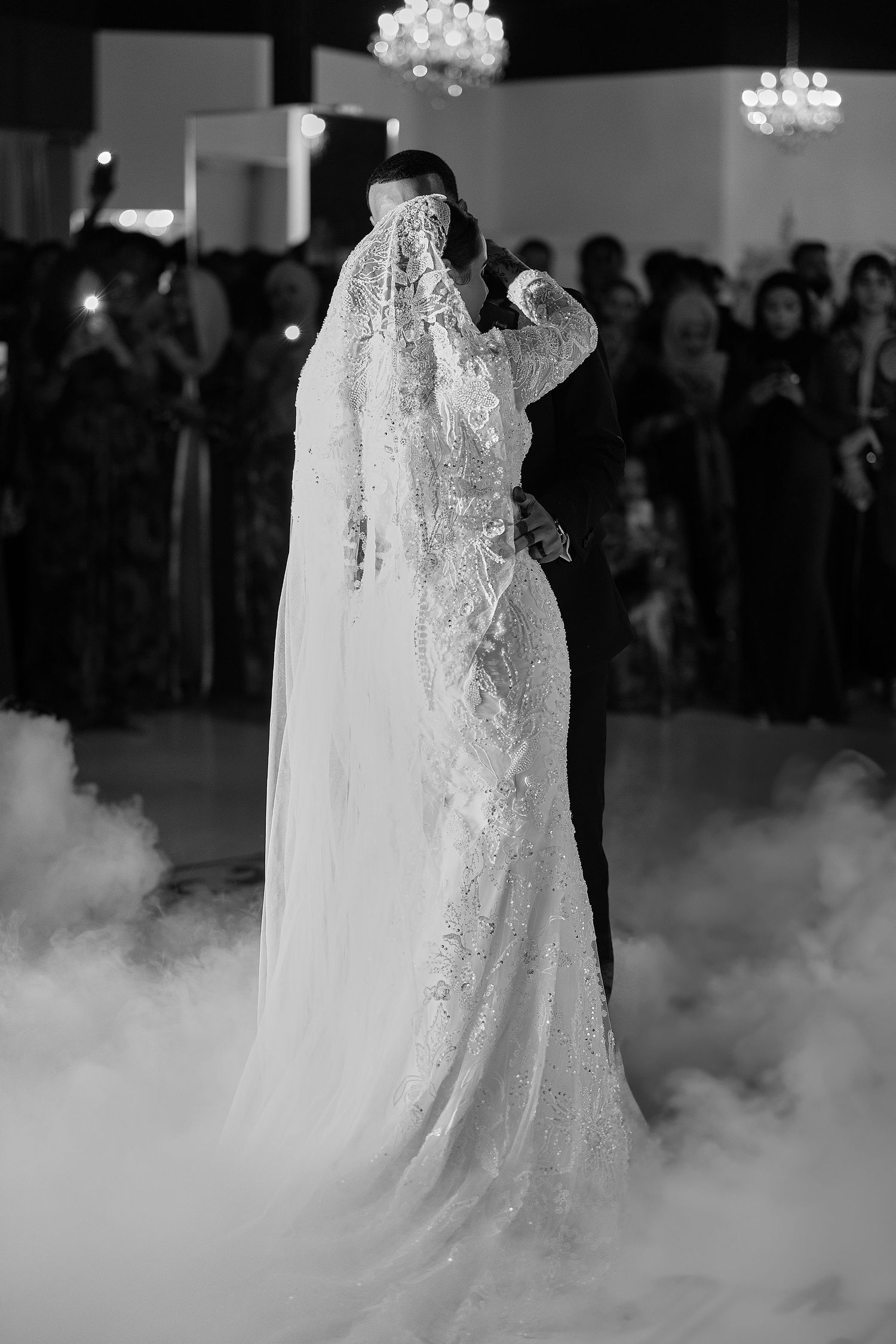 Dramatic wedding scene with fog effects and elegant lace dress silhouettes.