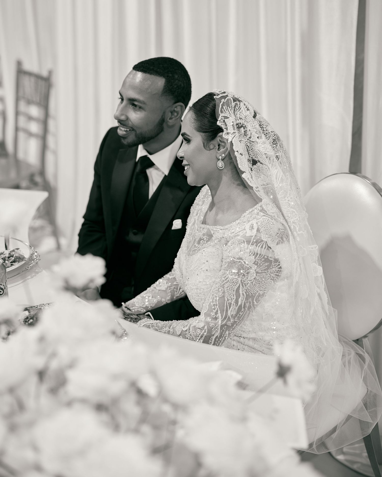 Black and white wedding reception moment captured with elegant decor and drapery.