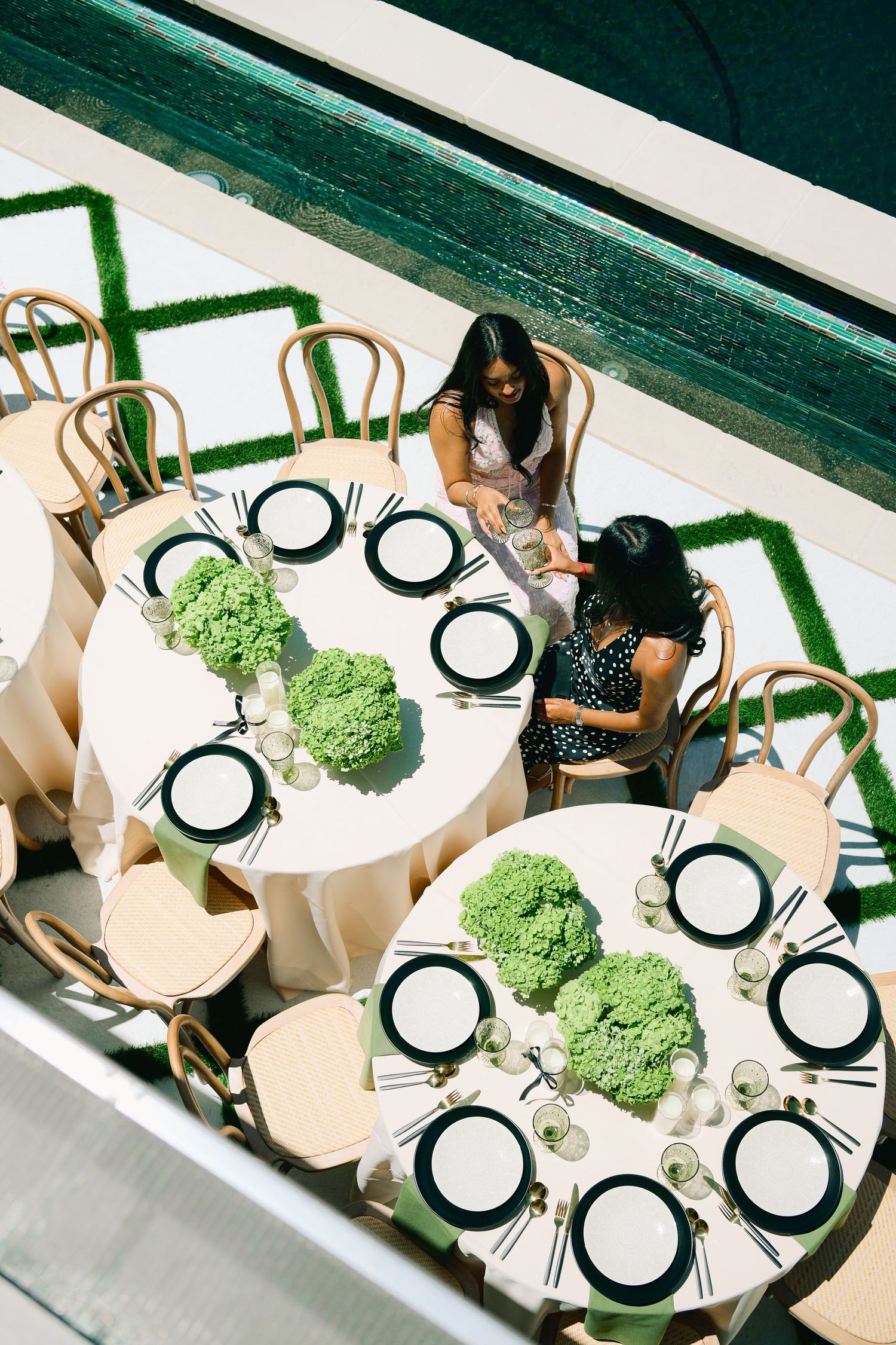Overhead view of elegant round dining tables set with green hydrangea centerpieces.