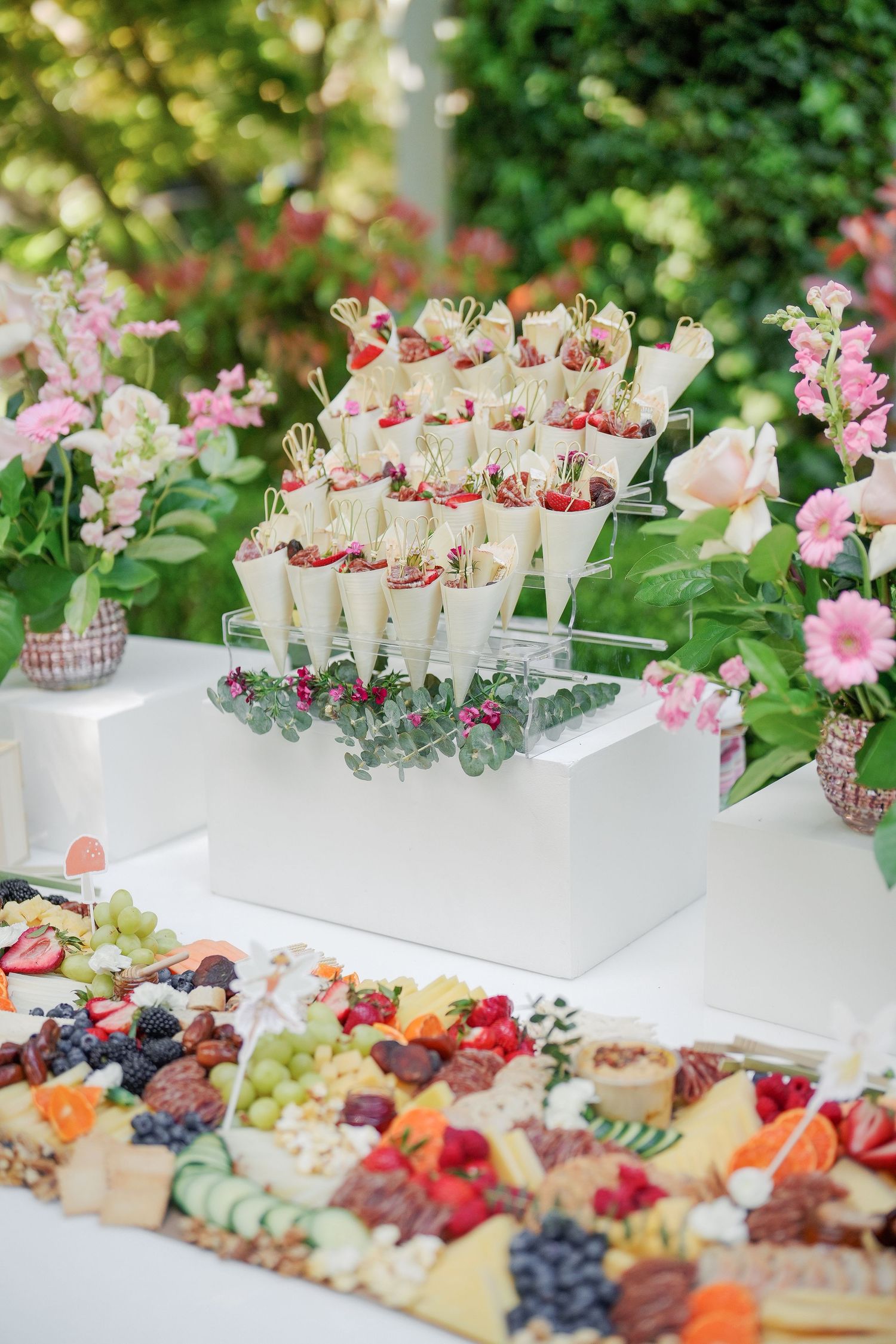 Luxurious grazing table with assorted cheeses, fruits, and appetizers elegantly displayed.