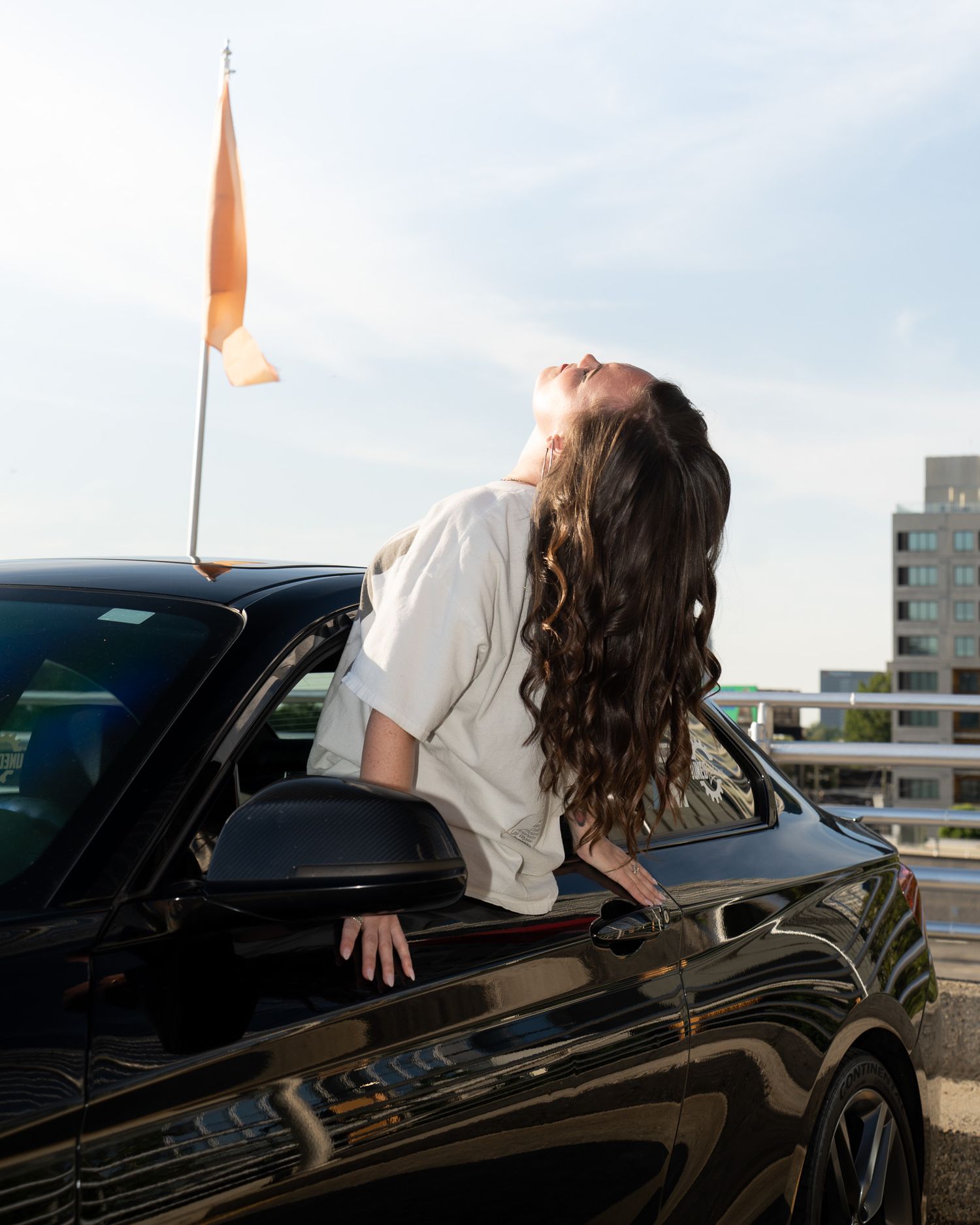 Atlanta model with flowing hair out of BMW car window