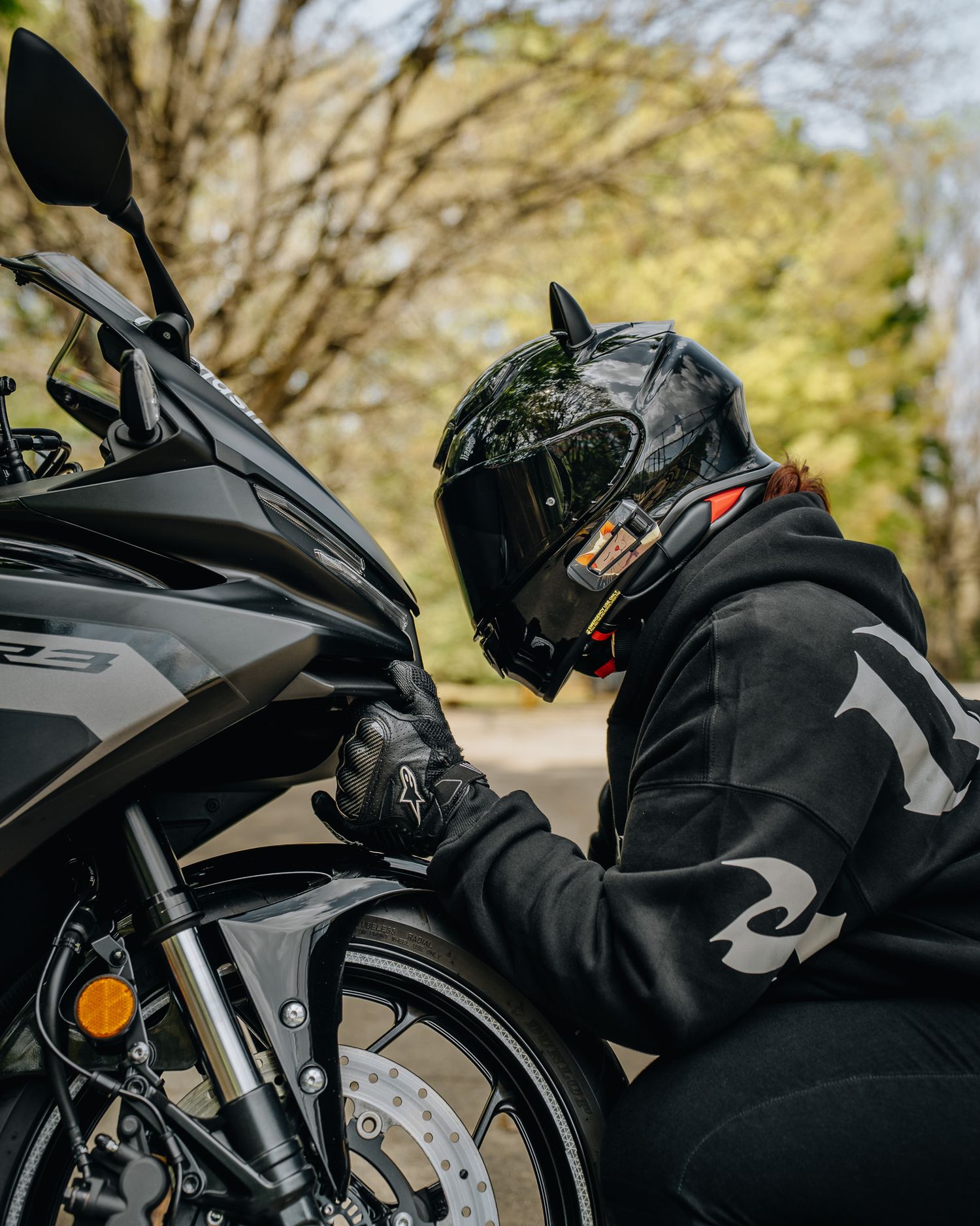Portrait of Atlanta biker girl with black motorcycle at Perkerson Park