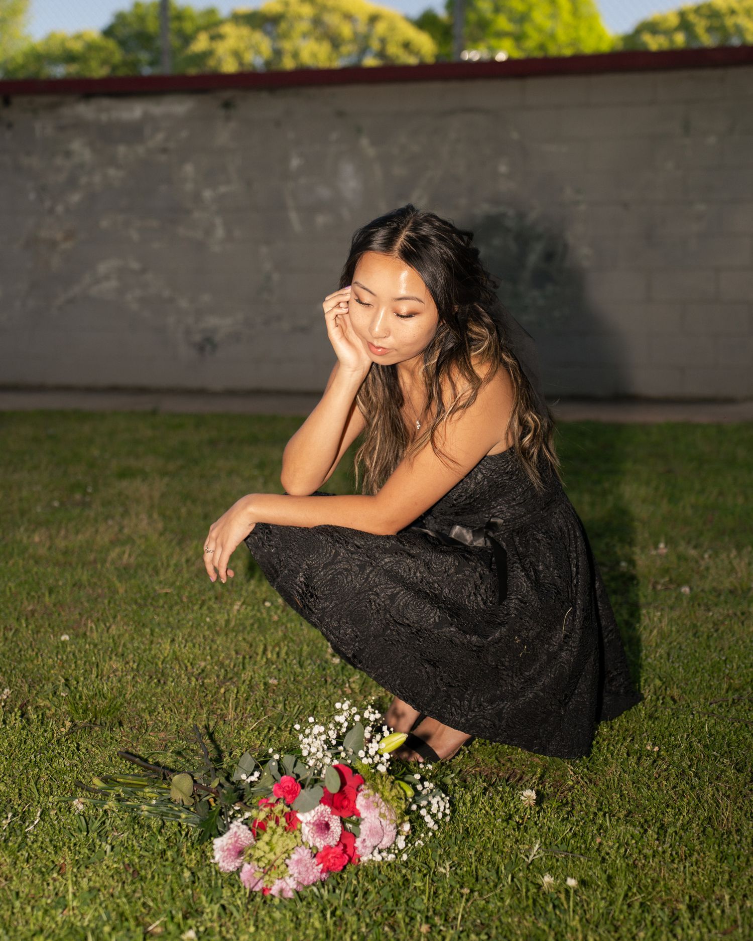 Portrait Photo at Perkerson Park in Atlanta, GA in the grass with flowers and black dress
