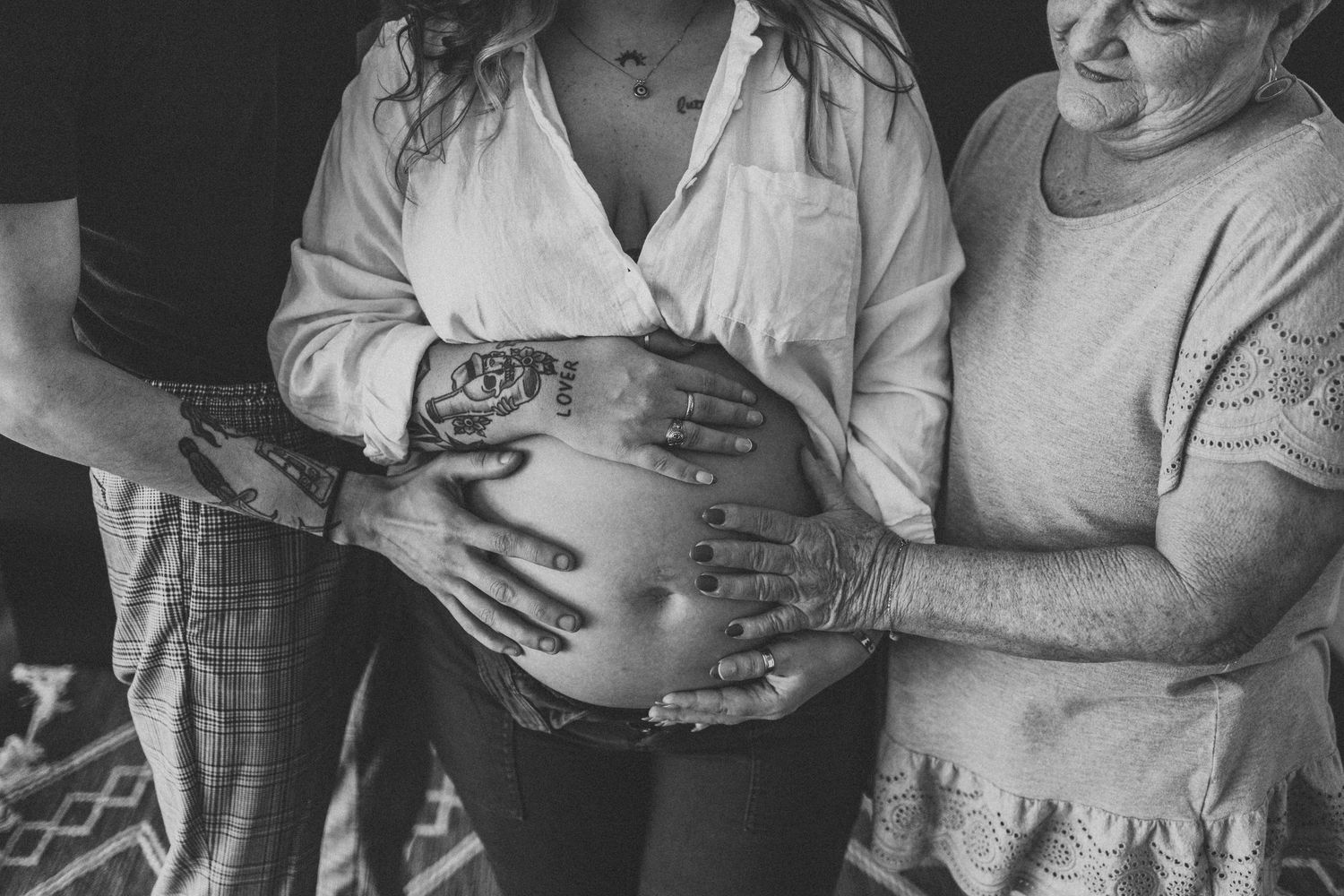Black and white candid moments of family bonding with newborn.