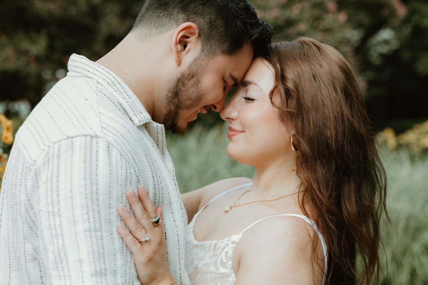 Romantic outdoor couple photo shoot showing intimate moments between newlyweds in a garden setting.