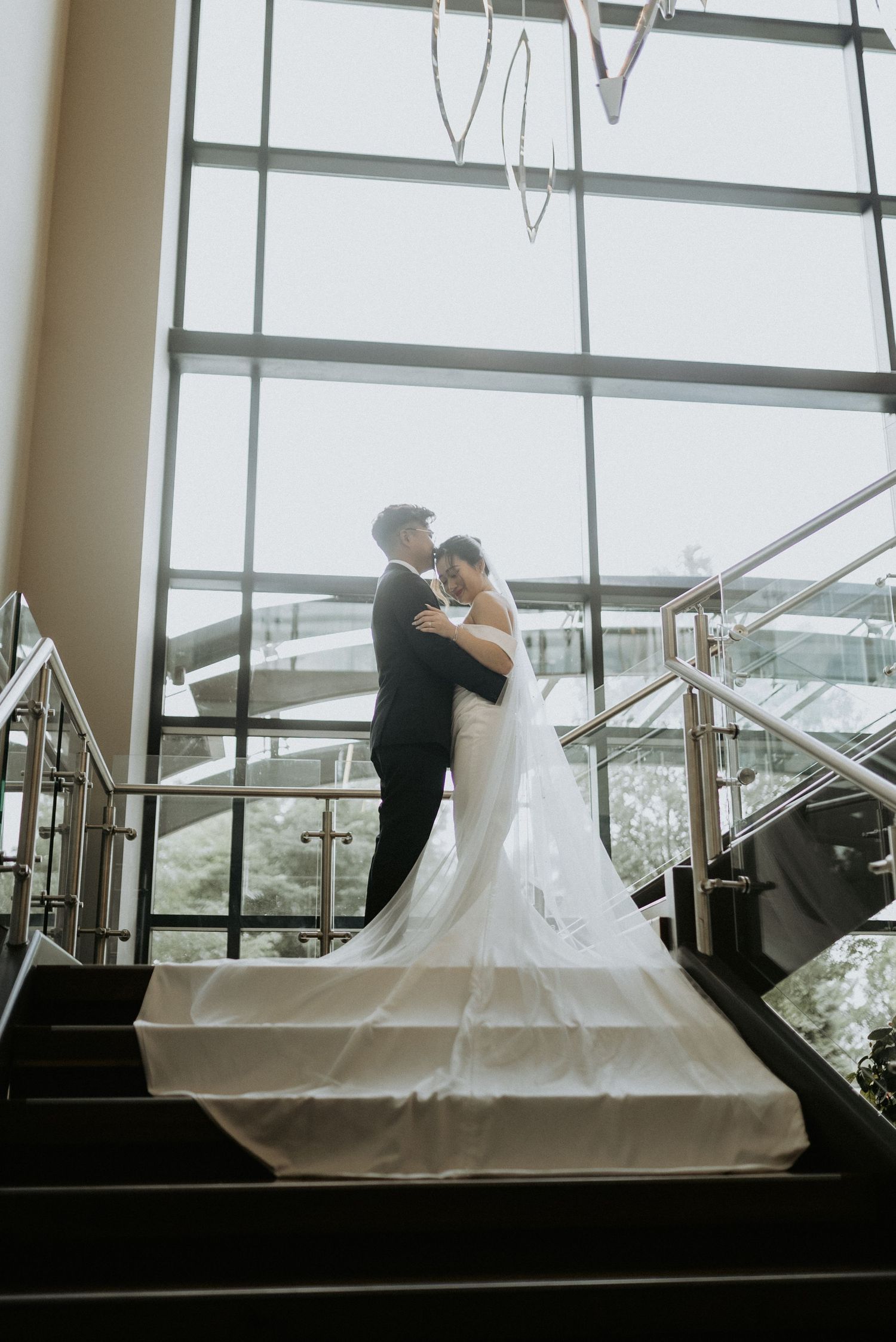 A romantic ballroom scene with a couple dancing together in silhouette against large windows.