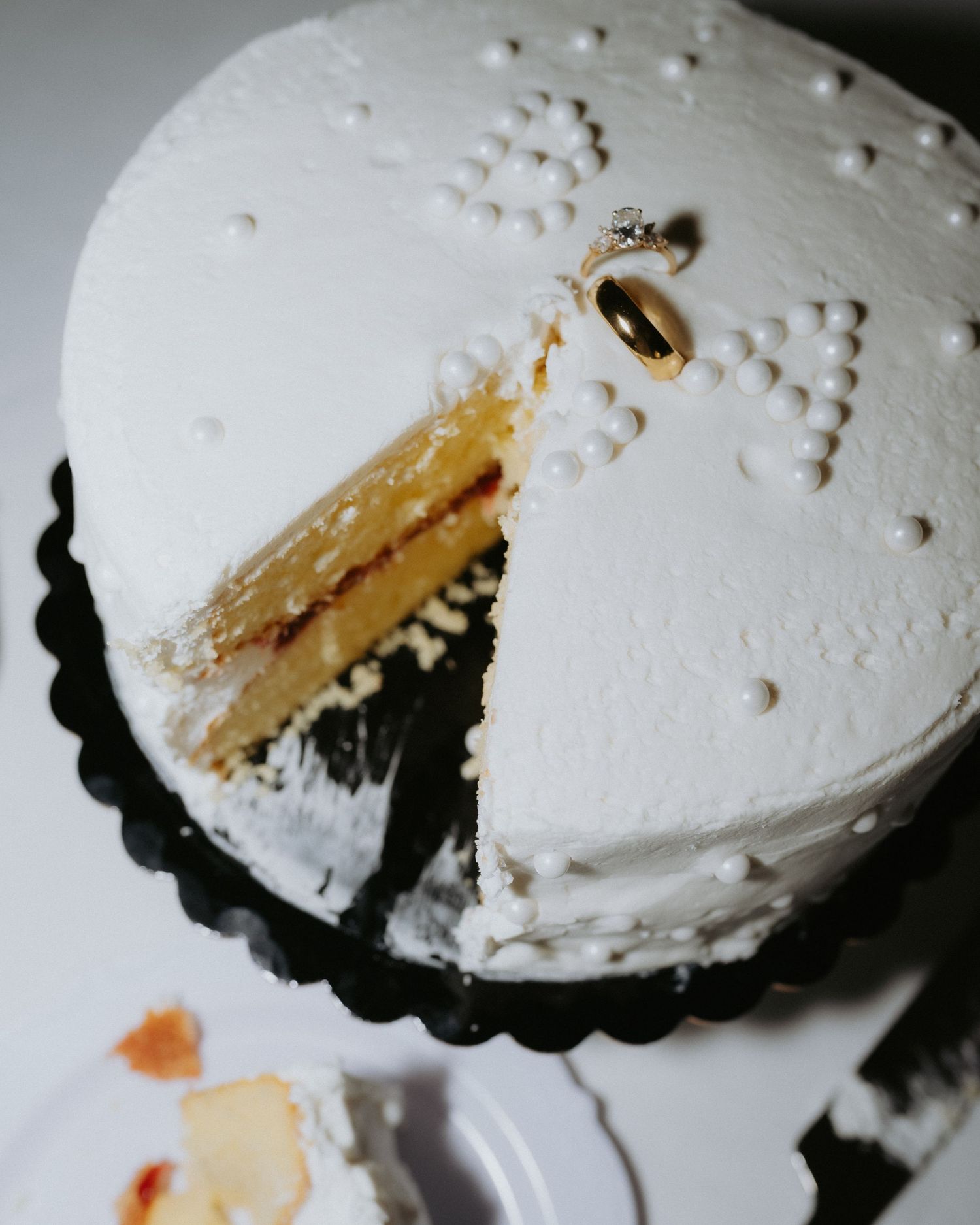 Six shots showing a white frosted cupcake in a black tin being eaten progressively from right to left.