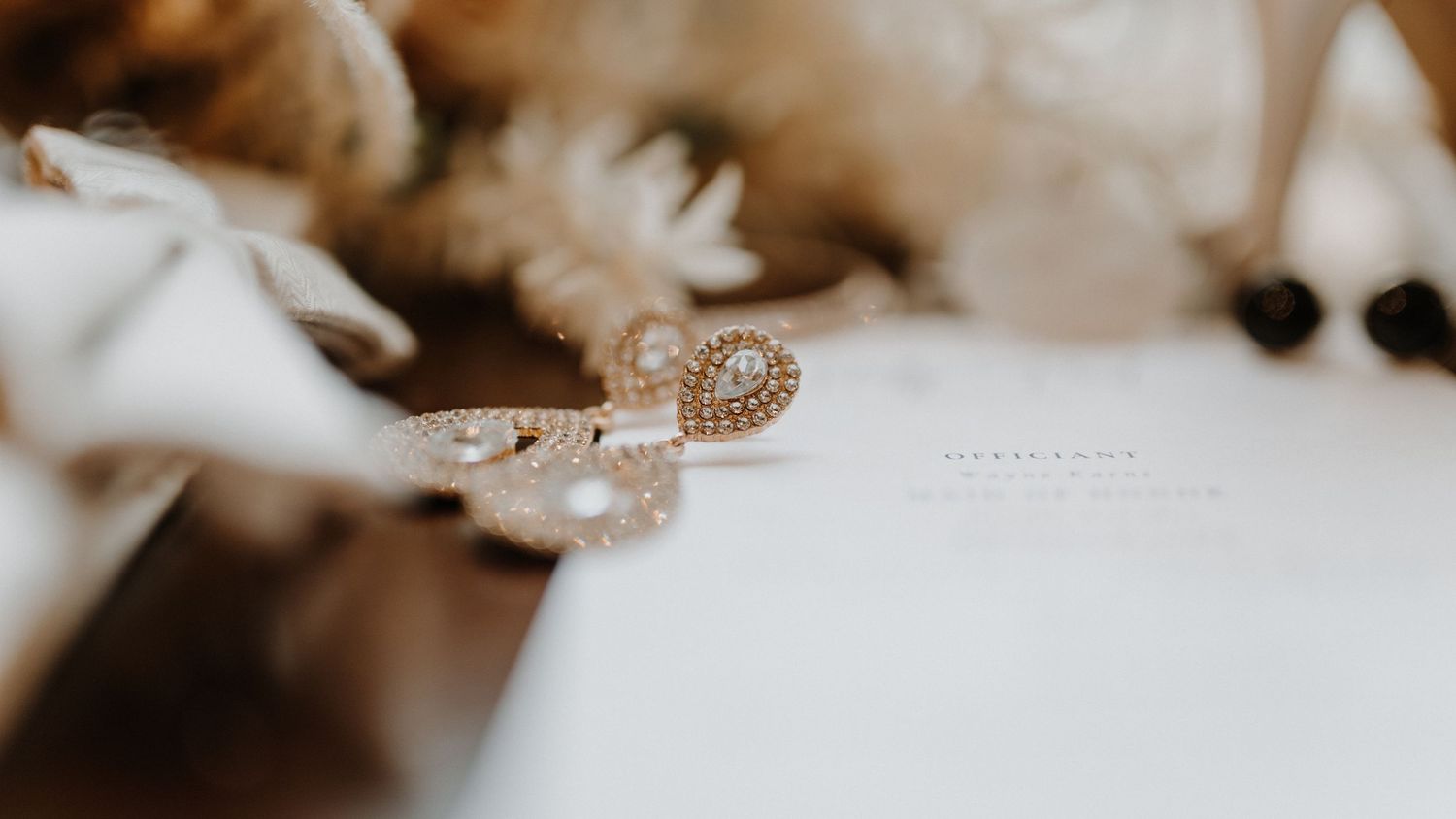 Delicate pearl jewelry details arranged for a wedding day close-up shot.