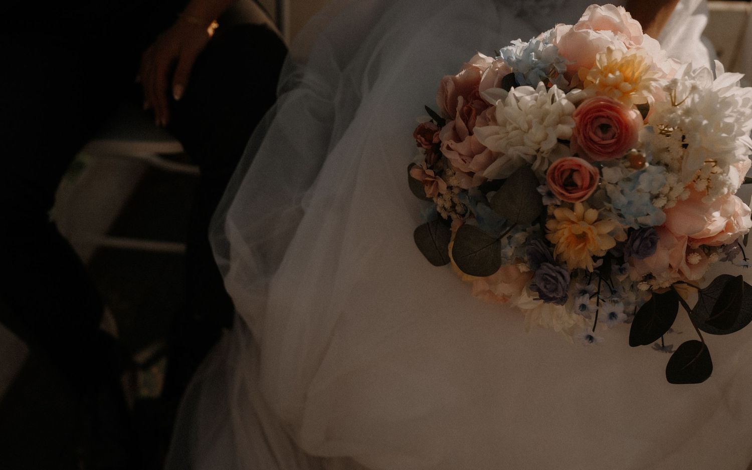 Beautiful floral arrangements and elegant decor at a glamorous wedding reception showcase white and peach color palette.
