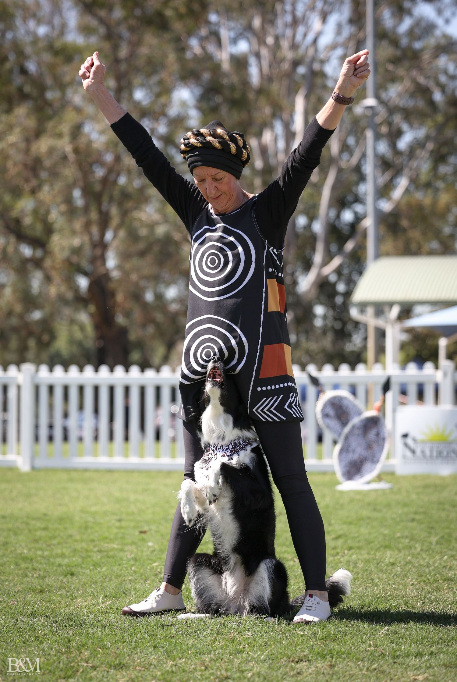 Border Collie and handler performing synchronized movements during agility training.