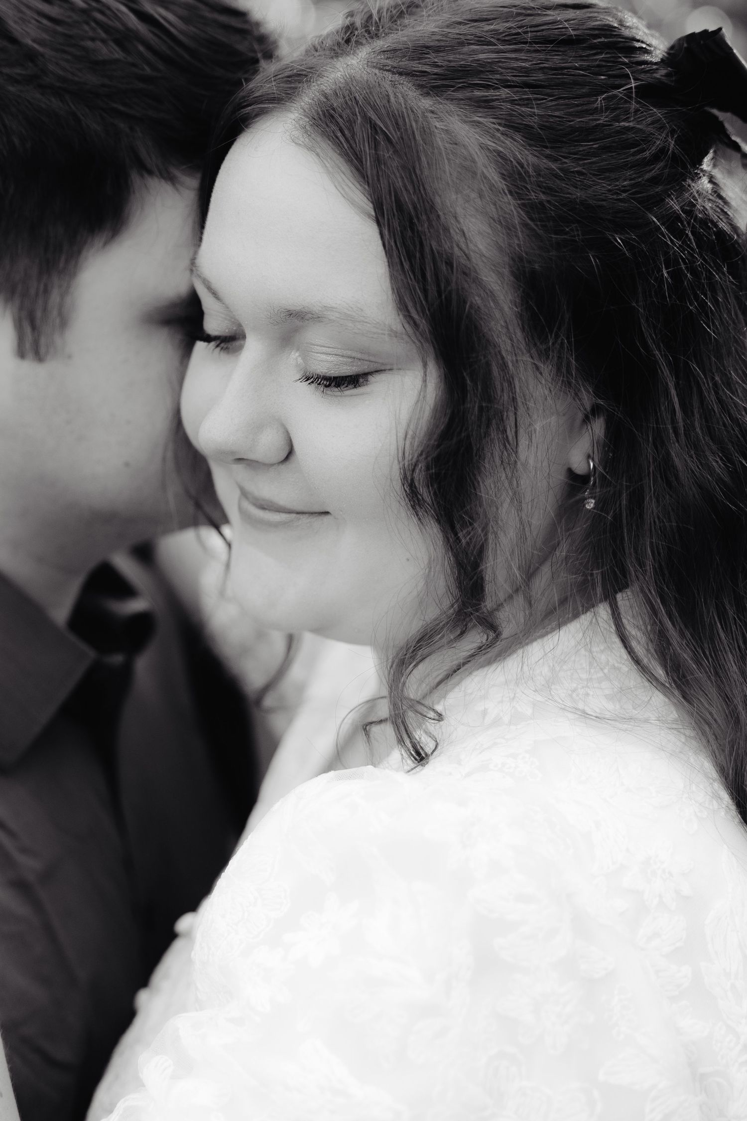 A sequence of intimate black and white photographs showing a romantic couple in tender close-up moments.