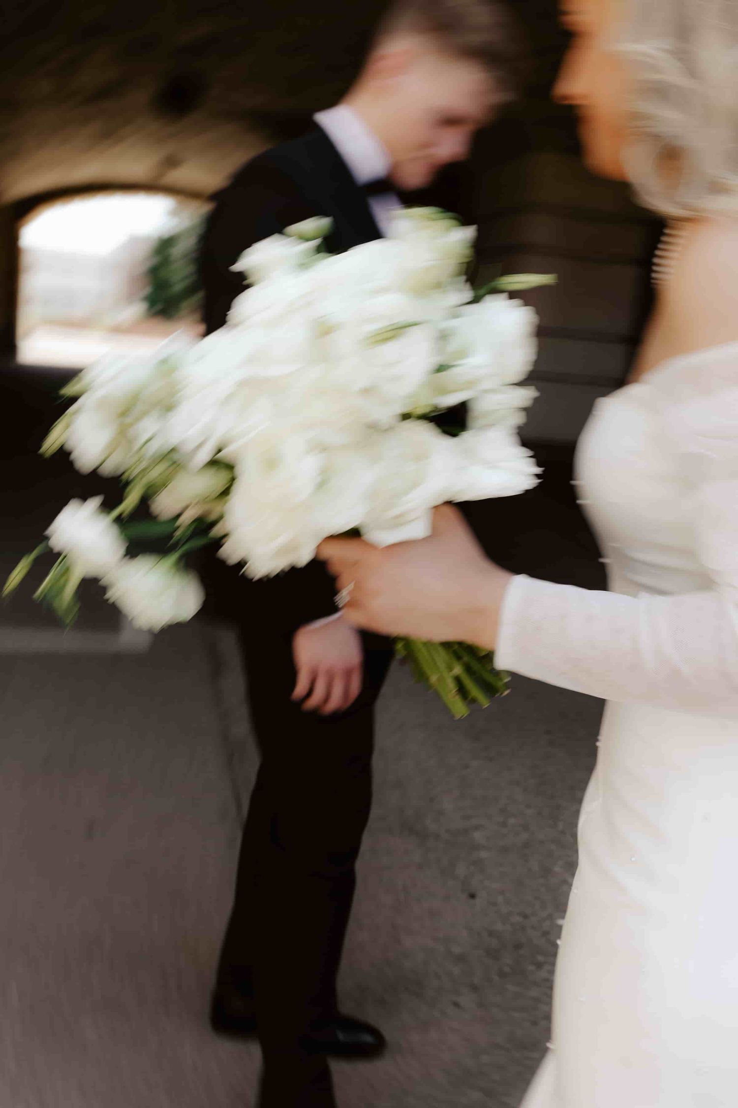 wedding photos at the Nebraska State Capitol Building in Lincoln Nebraska, bride holding her wedding bouquet with white flowers
