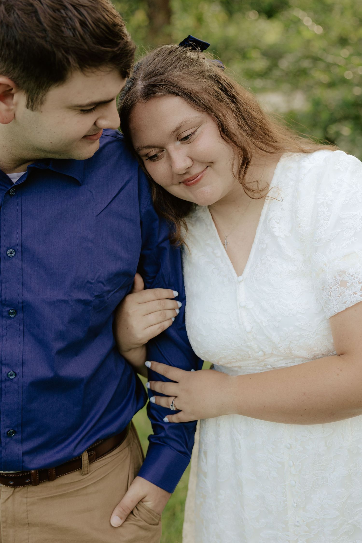 A romantic sequence of a couple sharing an intimate moment in a garden setting against greenery in their wedding attire.