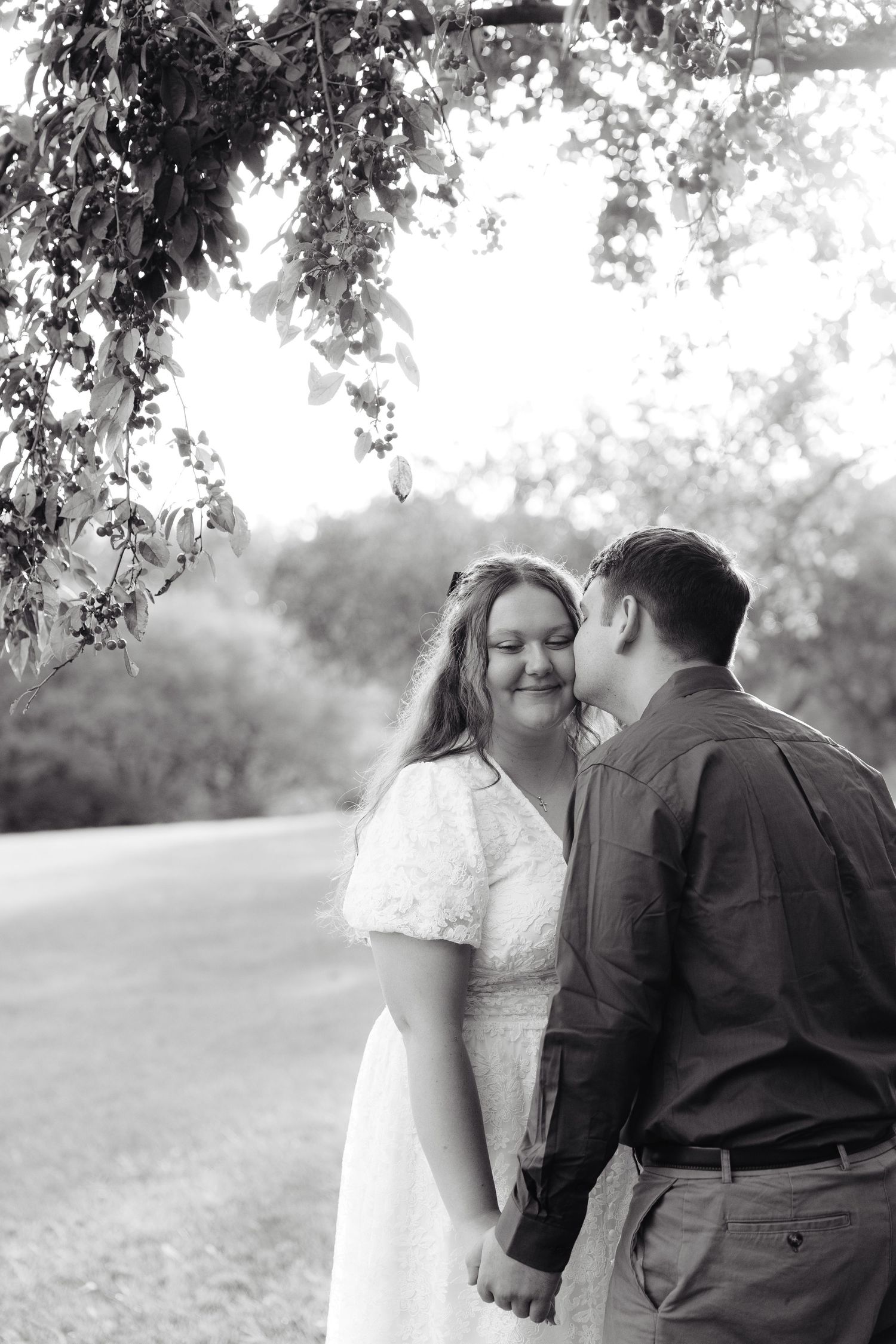 A romantic black and white wedding photography collage showing candid moments between newlyweds in a garden setting.