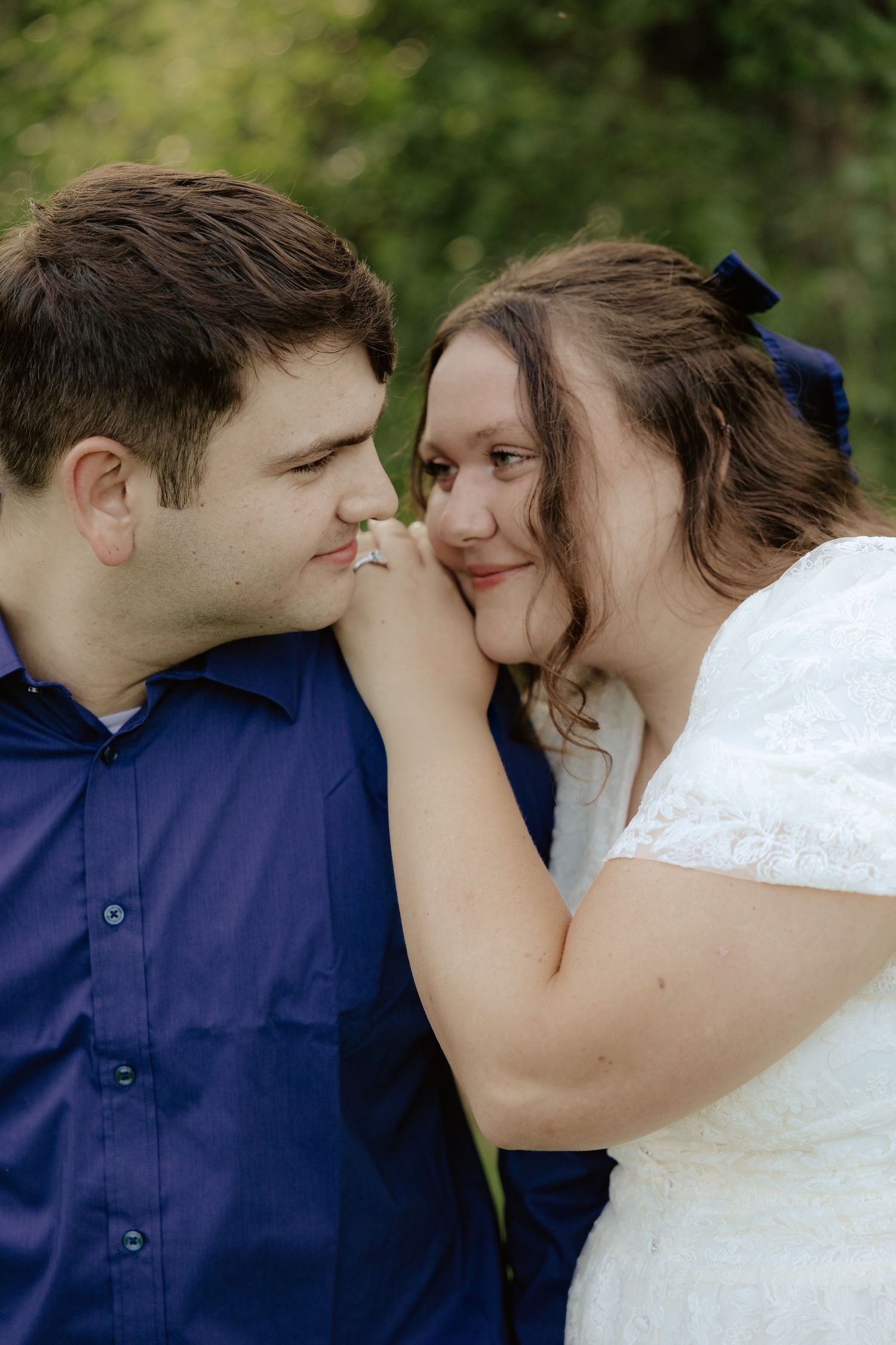 A romantic sequence of a couple sharing an intimate moment in a garden setting against greenery in their wedding attire.