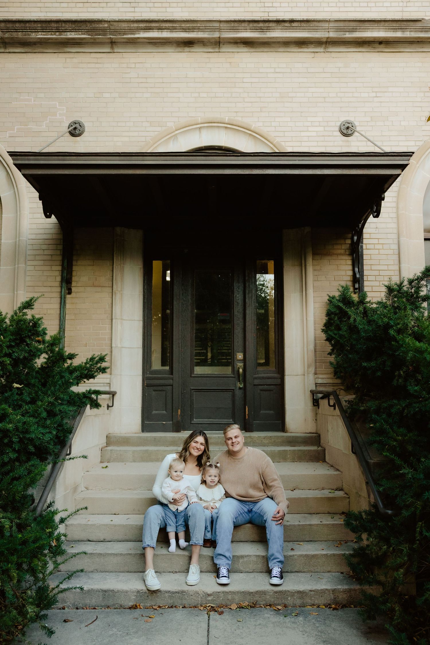 A series of progressive photos showing a family sitting together on concrete steps outside a building entrance.