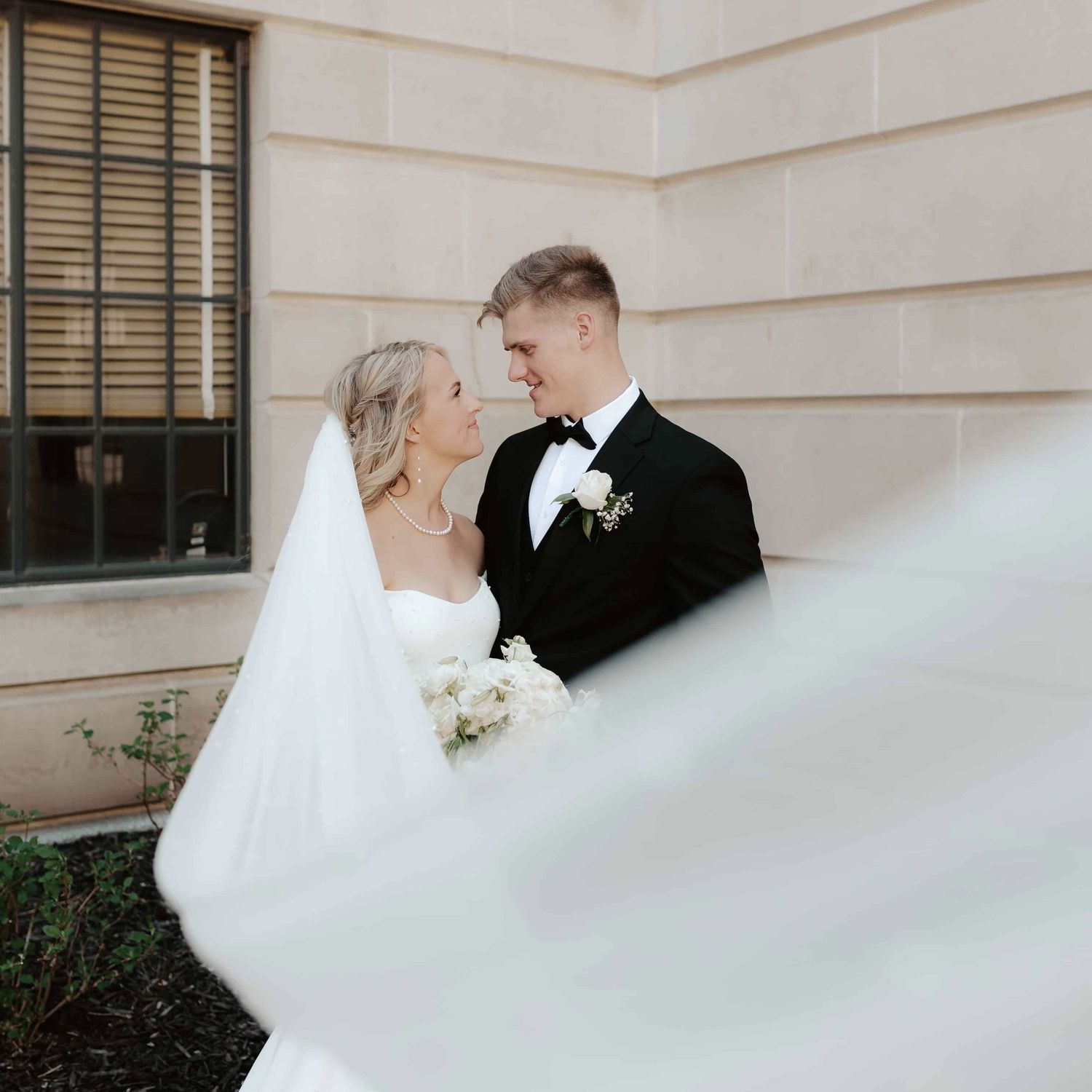 Bride and groom sharing a romantic sunset moment at a wedding in Lincoln NE, affordable wedding photographers lincoln nebraska