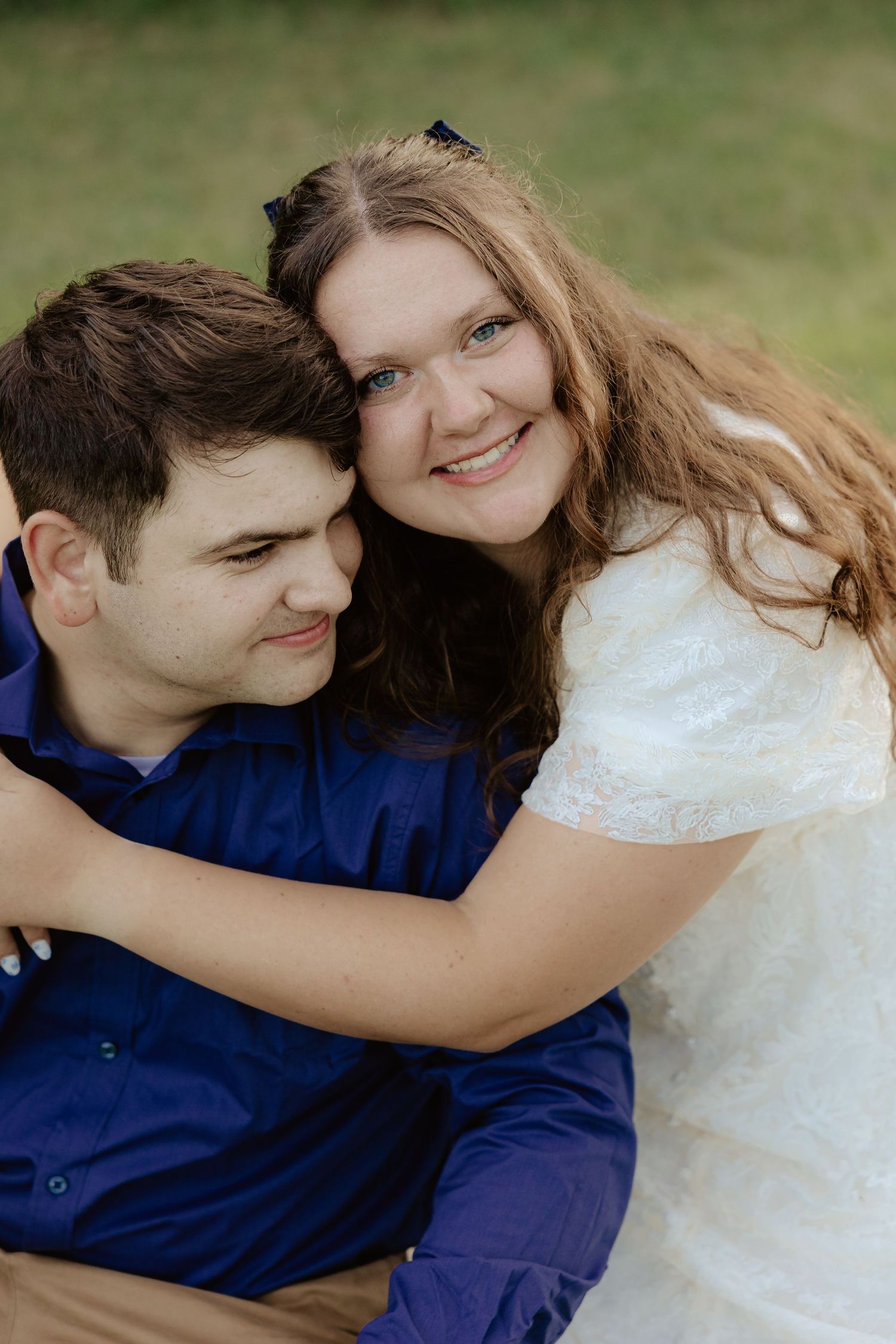 A romantic couple in white and navy blue share playful embraces in a series of tender outdoor portrait shots.