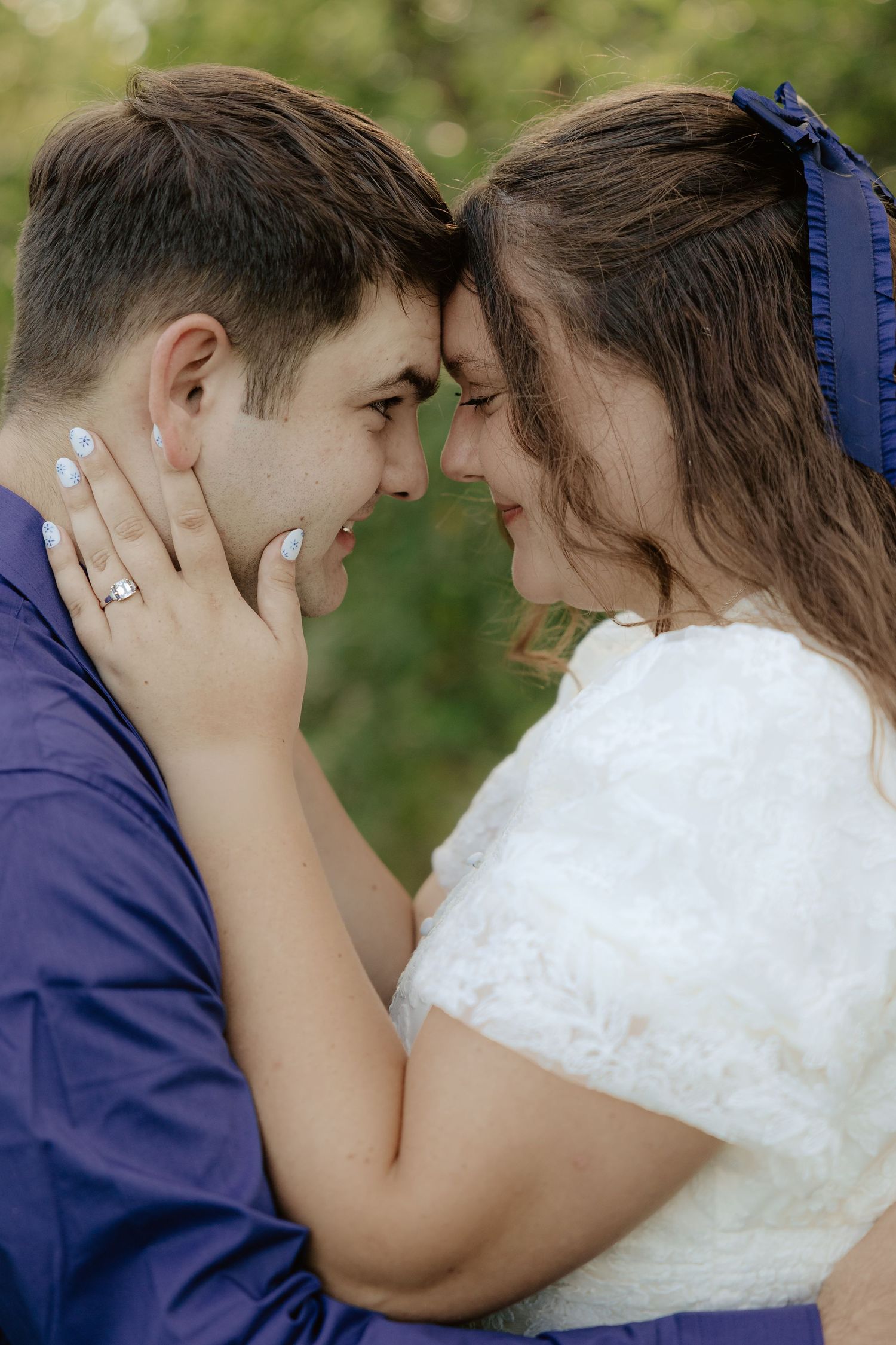 A romantic sequence of a couple sharing an intimate moment in a garden setting against greenery in their wedding attire.