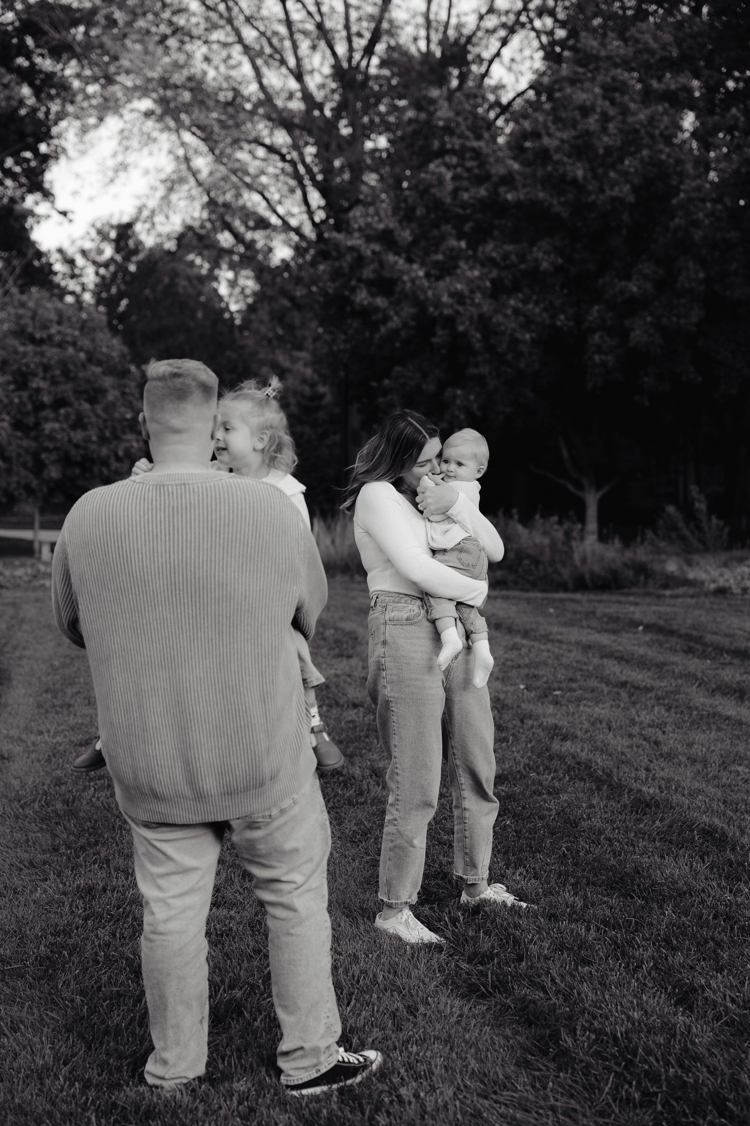 Black and white photo series showing people walking together on a grassy hillside at sunset.