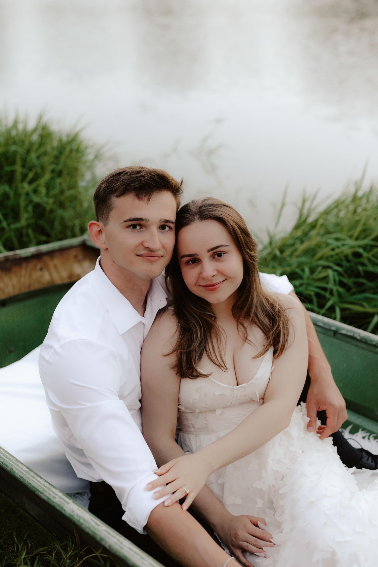 Beautiful couple sharing a romantic sunset in a canoe on a pond in Nebraska