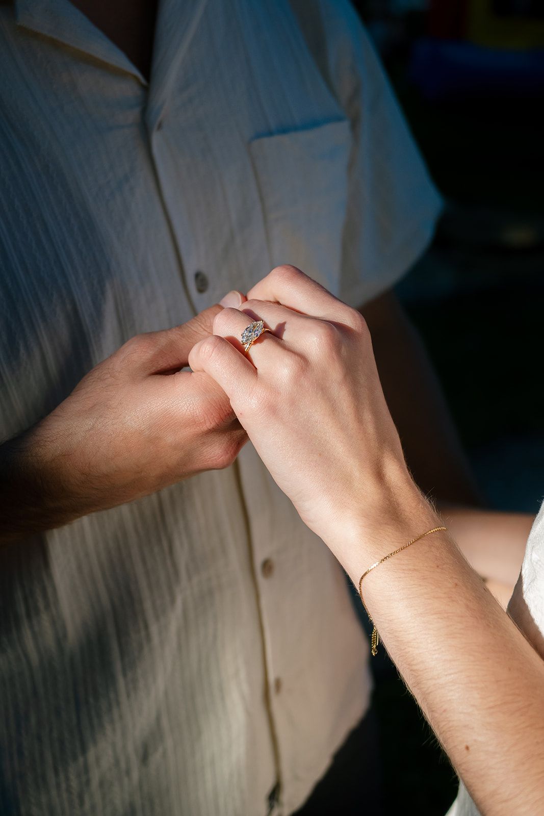 Close-up sequence of hands exchanging a diamond engagement ring in a romantic proposal moment.