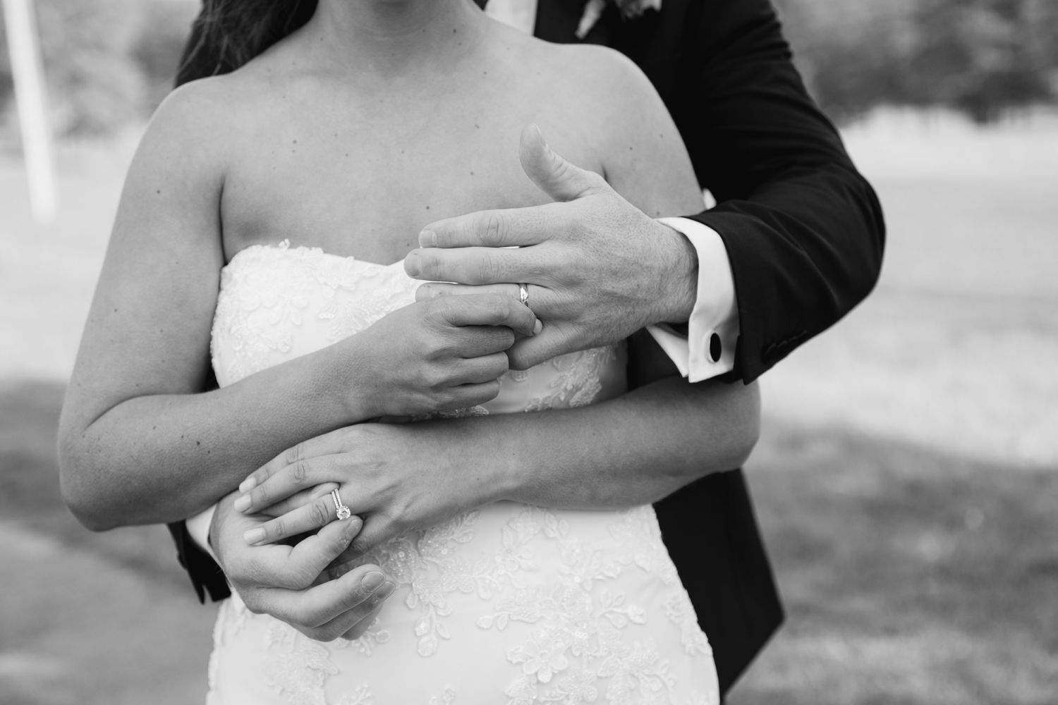 Black and white wedding photos showing couples embracing in romantic outdoor poses.
