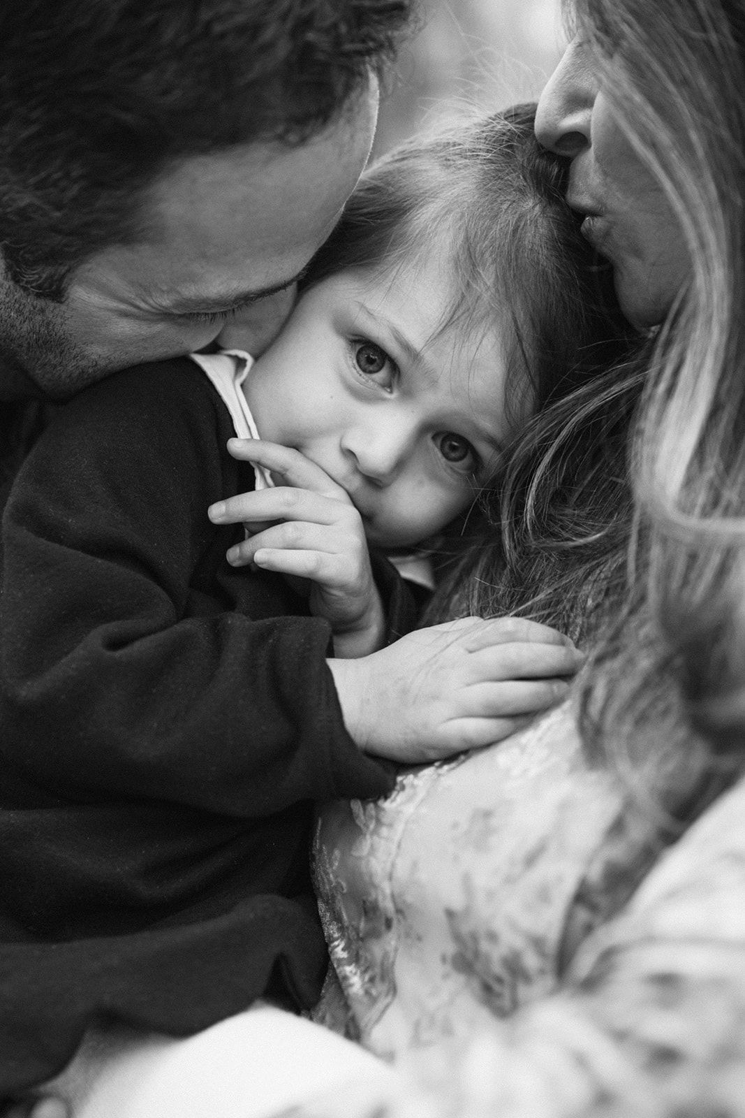 A series of black and white intimate photographs showing tender moments between two people in close proximity.