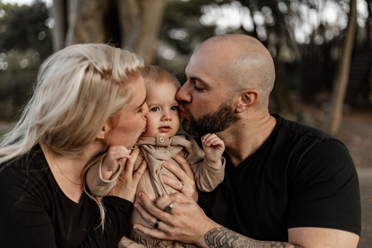 A family sharing a tender moment together outdoors during golden hour.