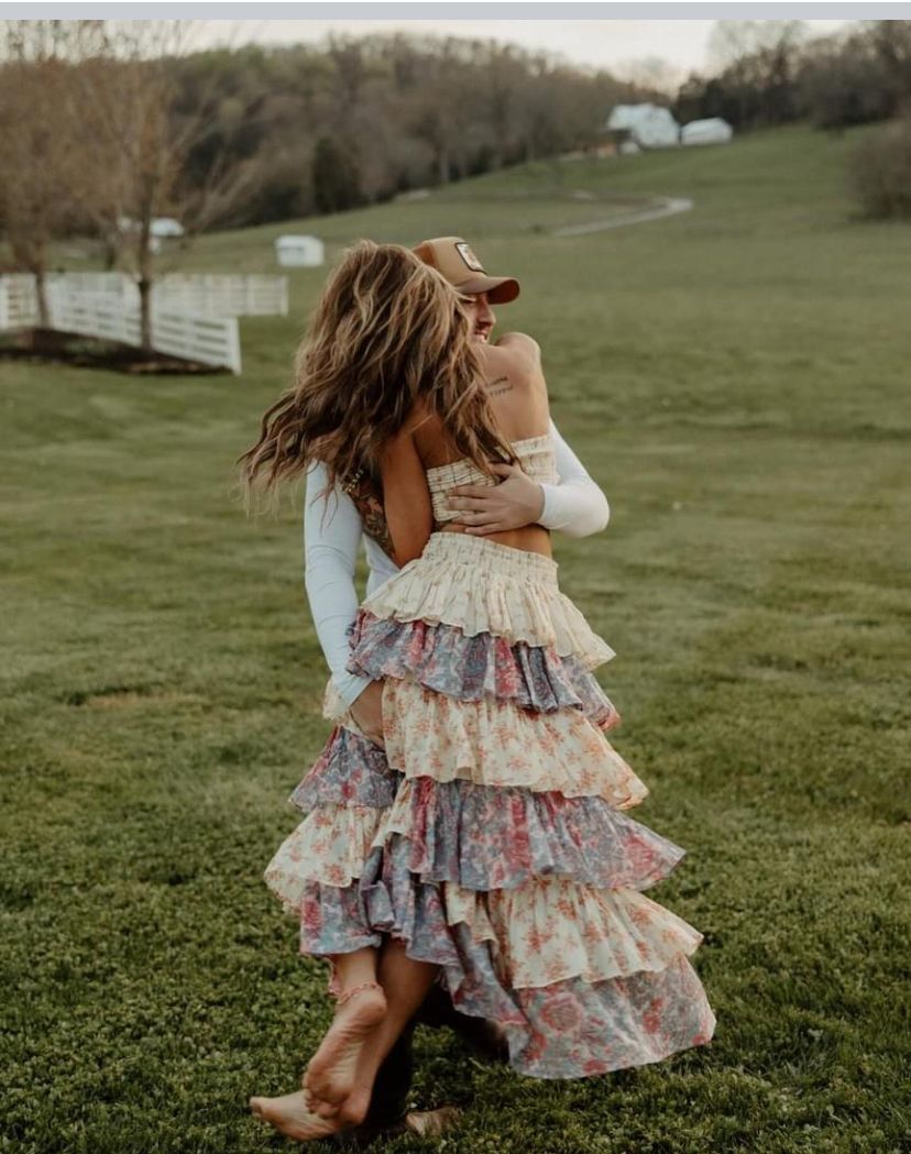 A series of candid photos showing a playful dance in a grassy field, with flowing floral dress movements captured at sunset.