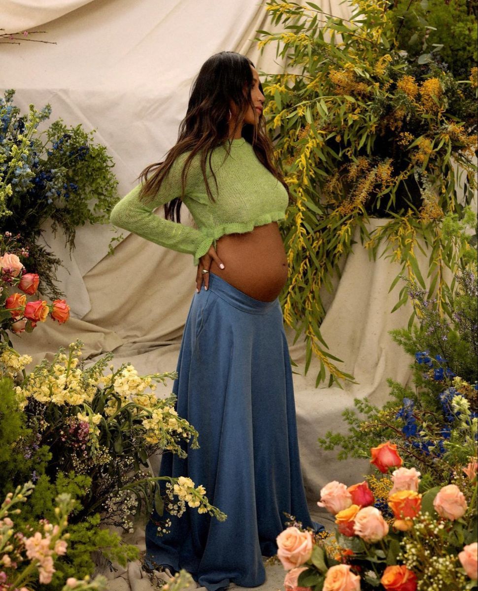A series of dreamy photos showing someone in a blue dress surrounded by colorful roses and garden flowers.