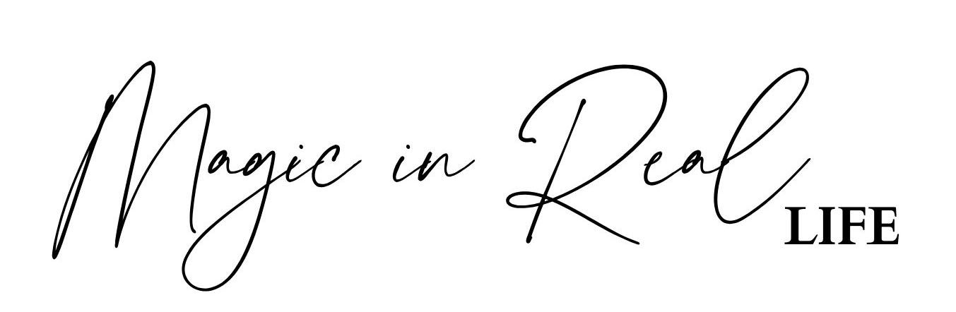 Elegant handwritten text reading 'Magic in Real Life' in black calligraphy style.